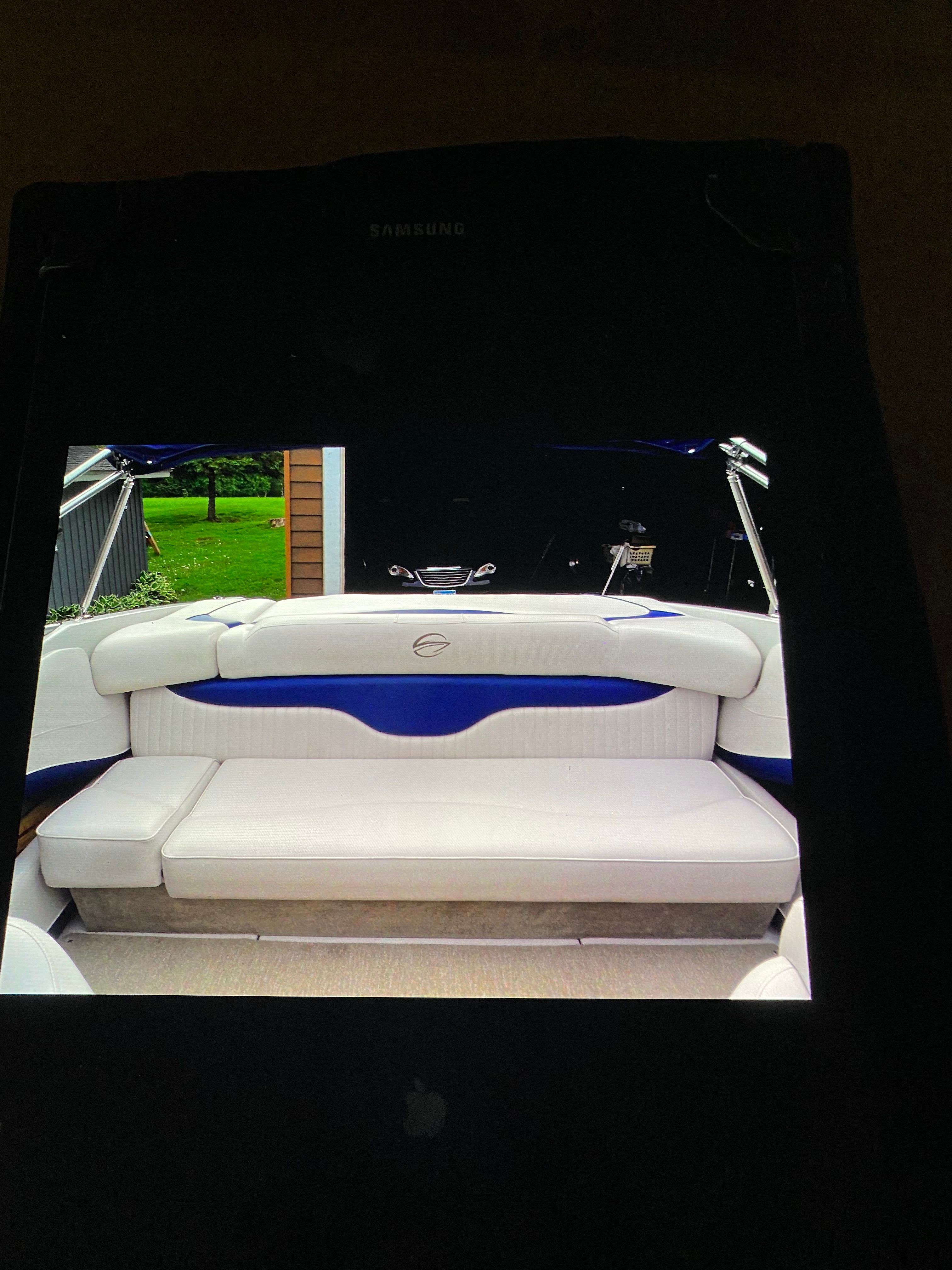 The image shows the interior of a Crownline 21 bow rider boat with white seating.