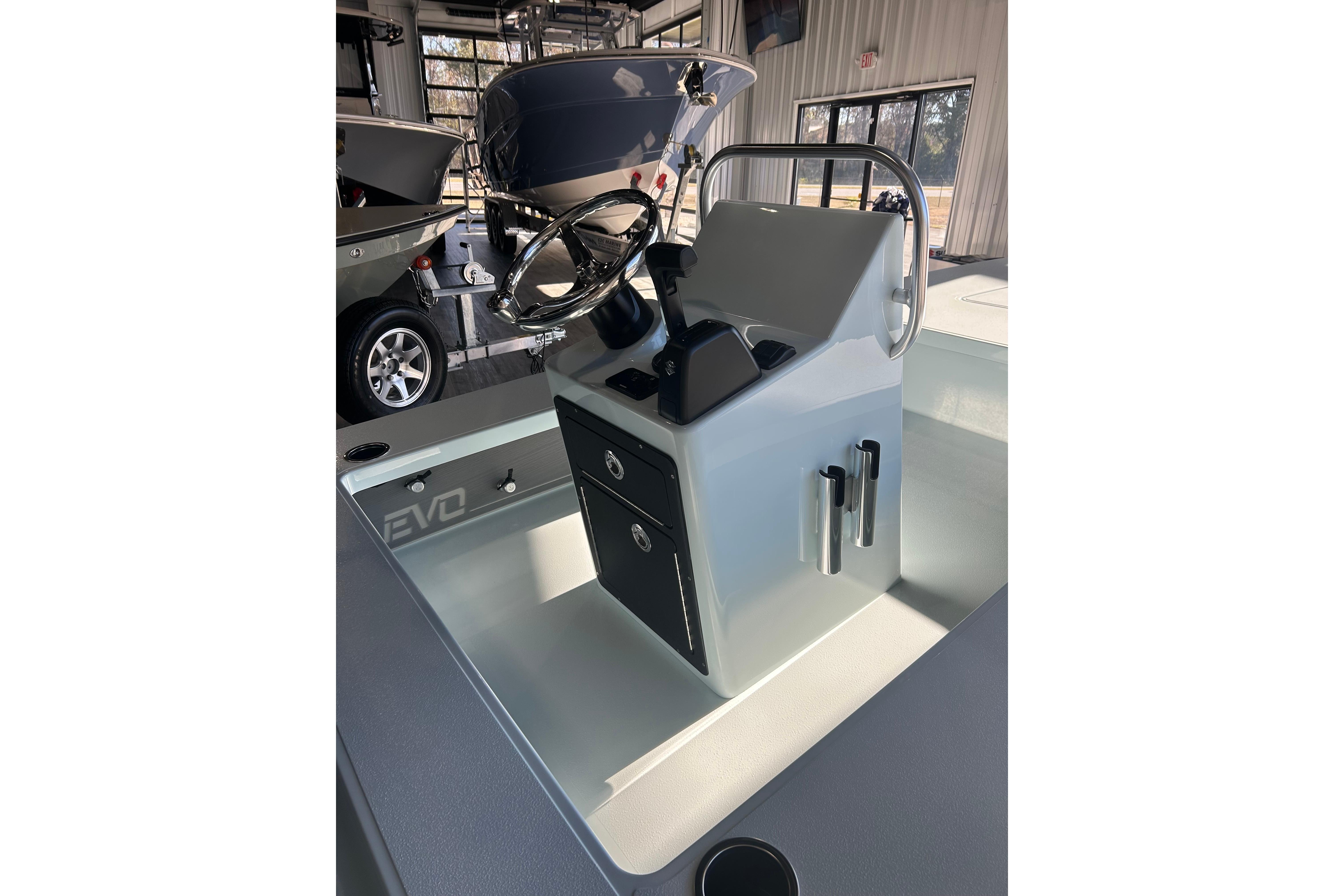 2026 East Cape Evo 17X boat console with steering wheel and storage compartments.