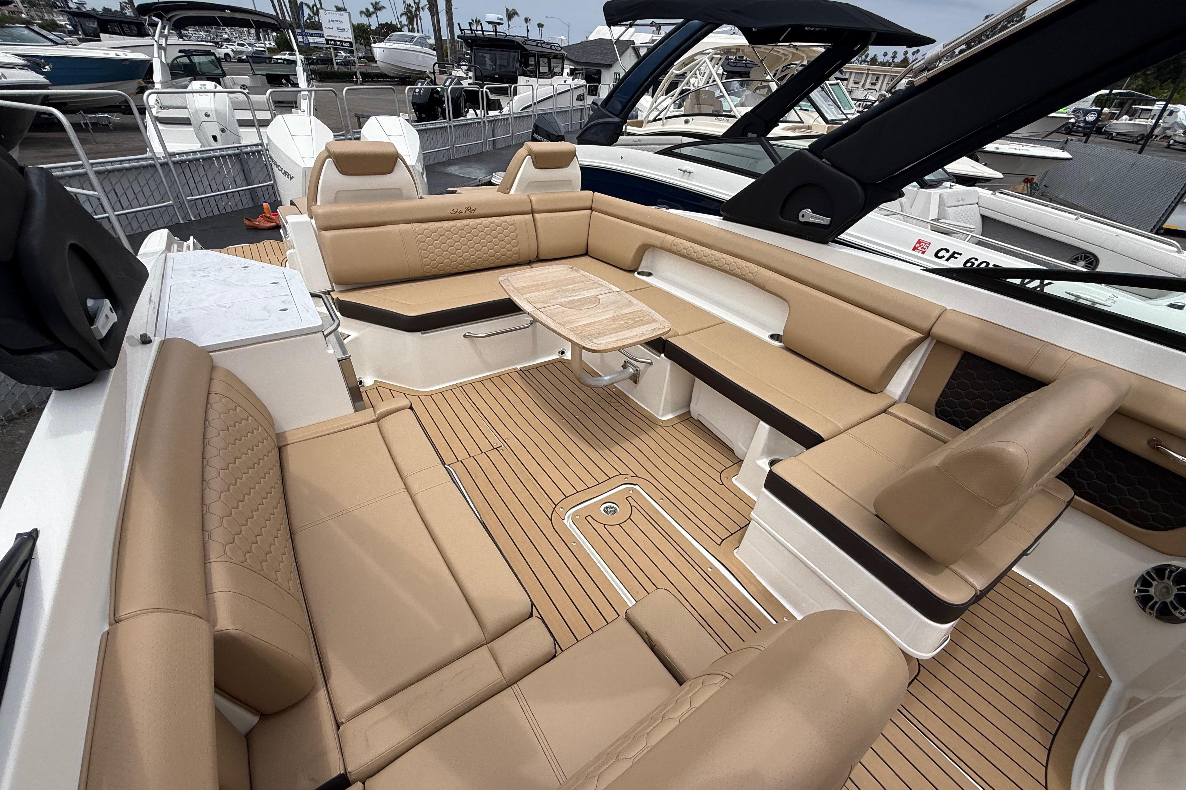 2022 Sea Ray SDX 290 Outboard boat interior with tan seating and wood flooring.