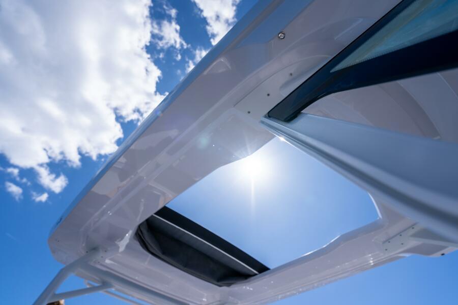 2025 Axopar 29 Sun-Top boat roof under blue sky.