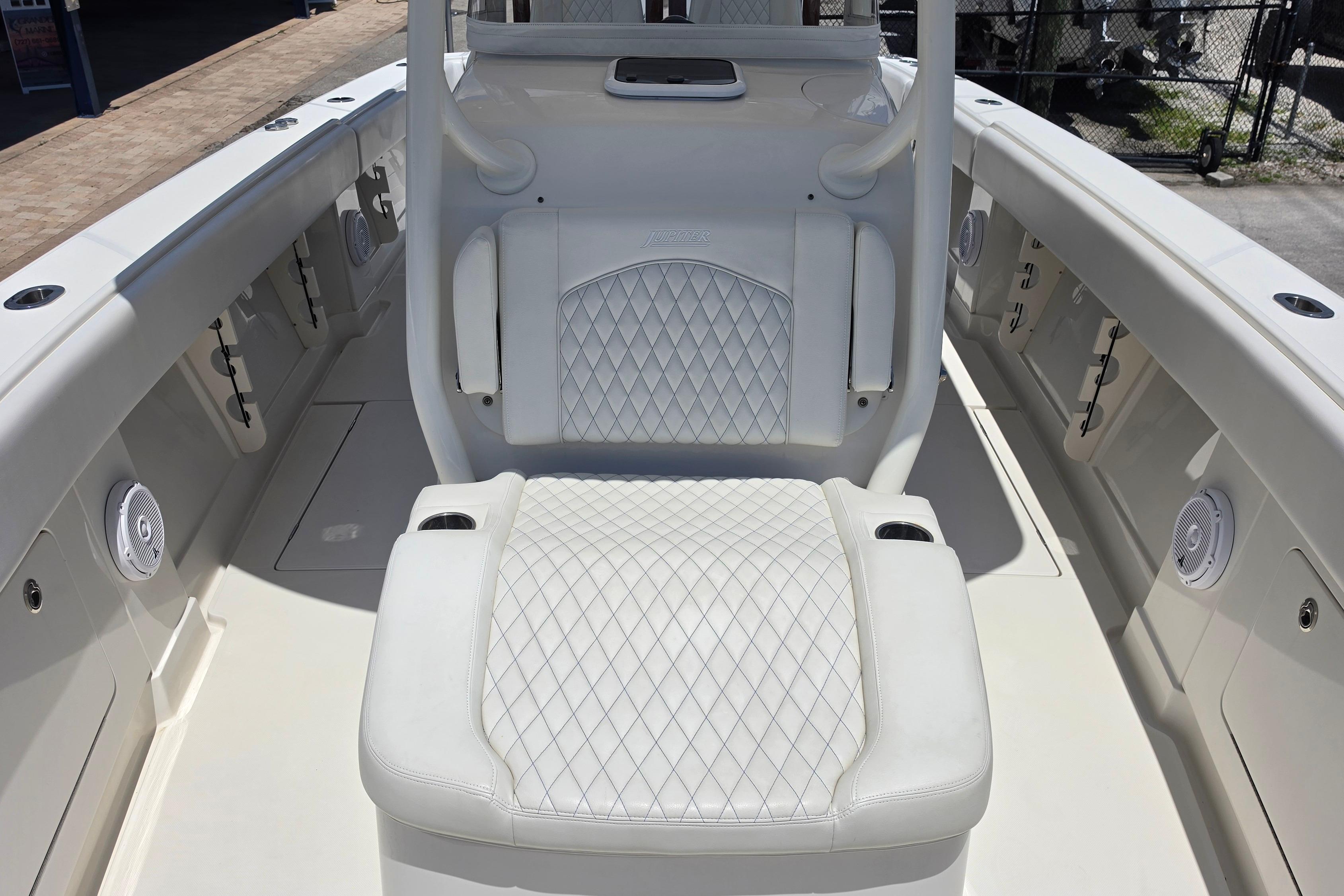 2020 Jupiter 34 HFS boat interior with white diamond-stitched seating and cup holders.