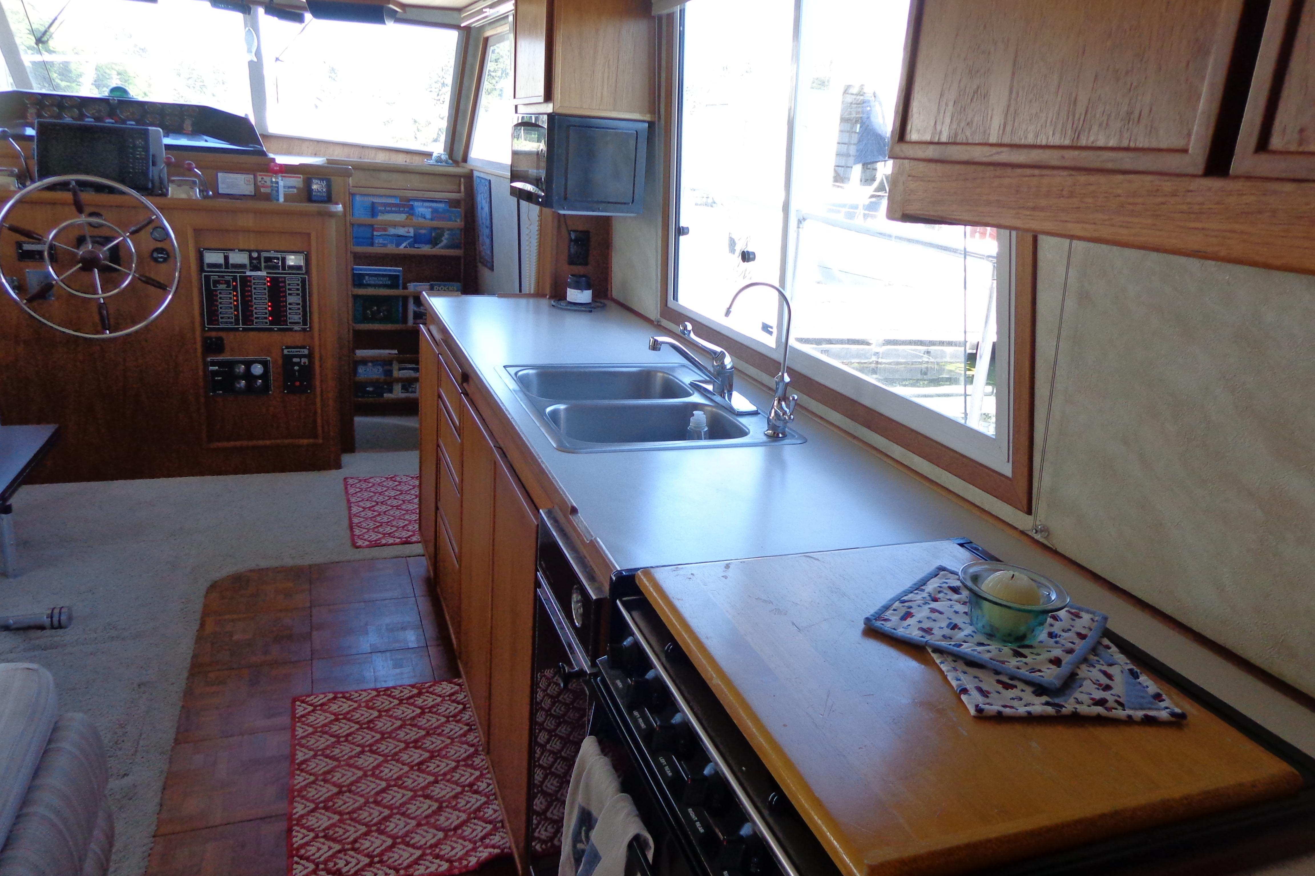 Interior of 1992 Cruise-A-Home Corsair 4200 with kitchen and steering area.