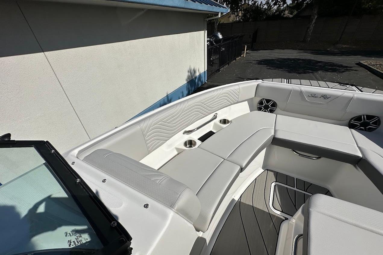 2026 Sea Ray SDX 230 Surf boat interior with white seating and cup holders.