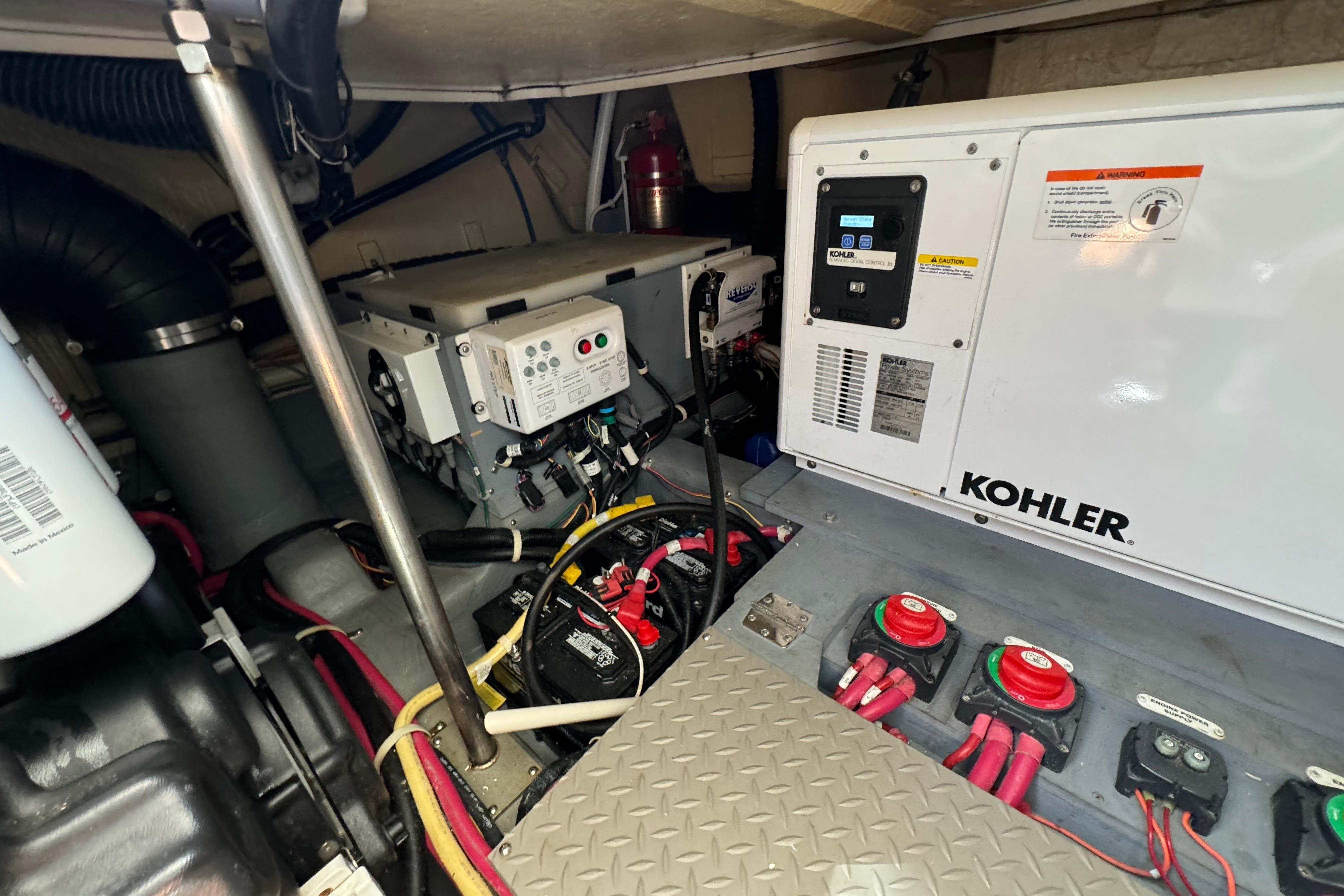 Engine room of 2017 Carver C40 Command Bridge with Kohler generator and electrical components.