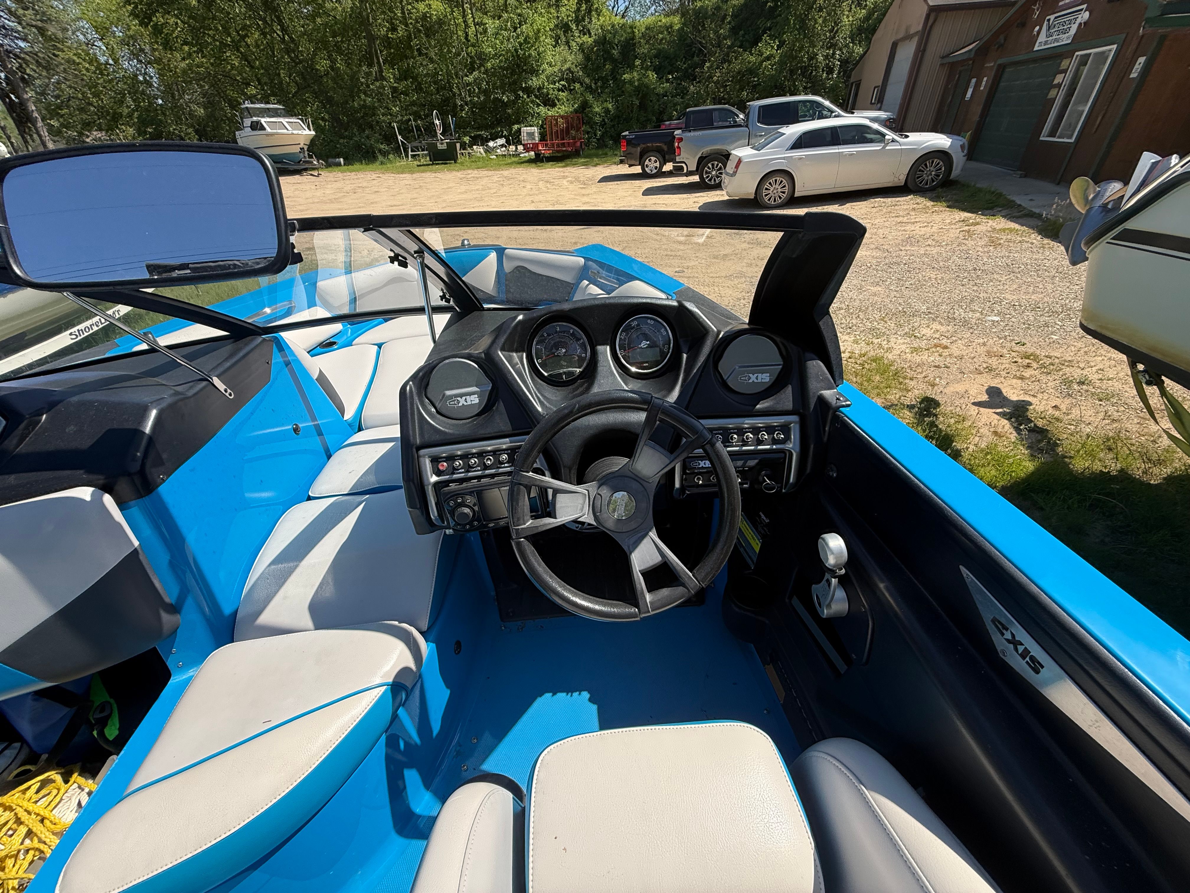 Interior of a 2015 Malibu Axis A20 boat with blue and white design.