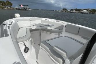 2023 Sea Fox 268 Commander boat interior with seating and table, docked by the water.