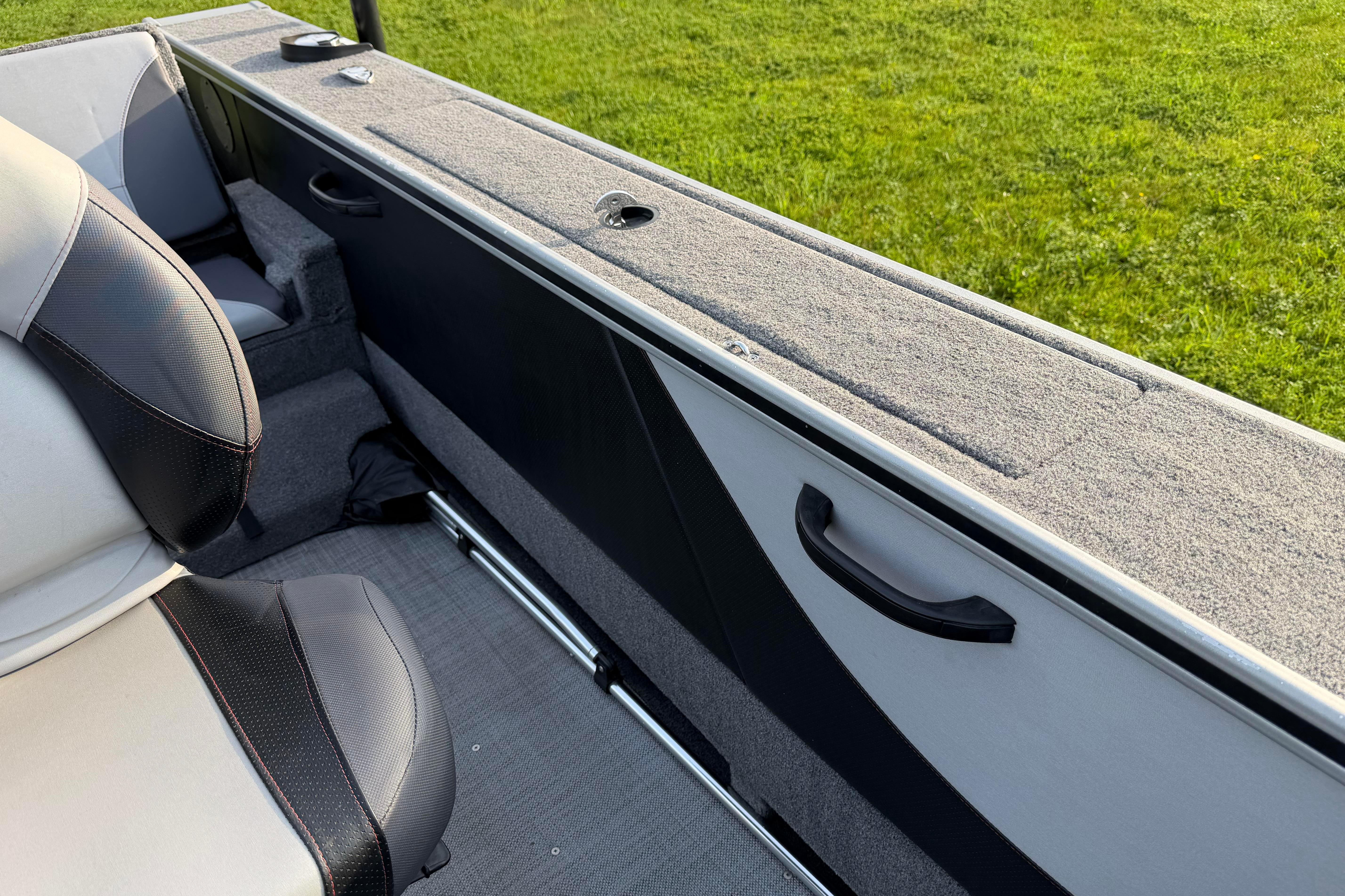 2019 Alumacraft Trophy 205 interior with cushioned seating and storage compartments.
