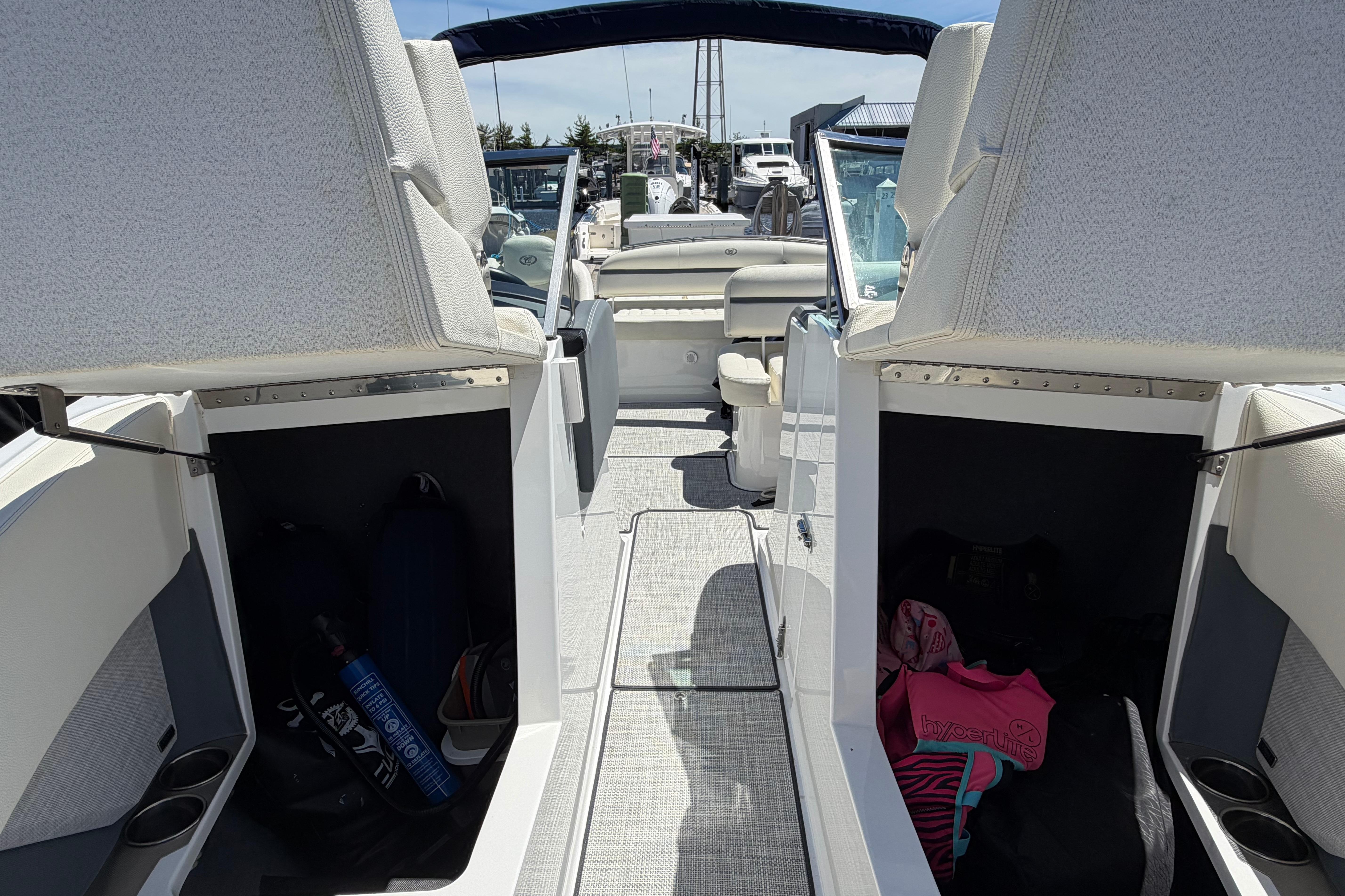 2020 Cobalt R3 boat interior with open storage compartments and seating area.