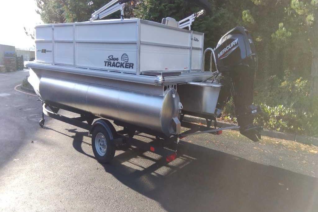2026 Sun Tracker Party Barge 16 DLX pontoon boat with Mercury outboard motor.