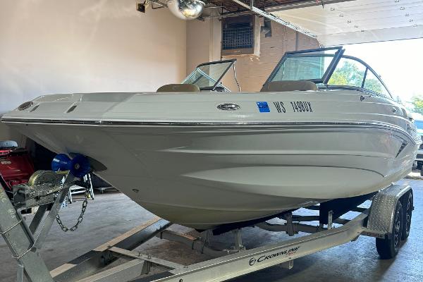 2023 Crownline 215 XS boat on trailer in garage setting.