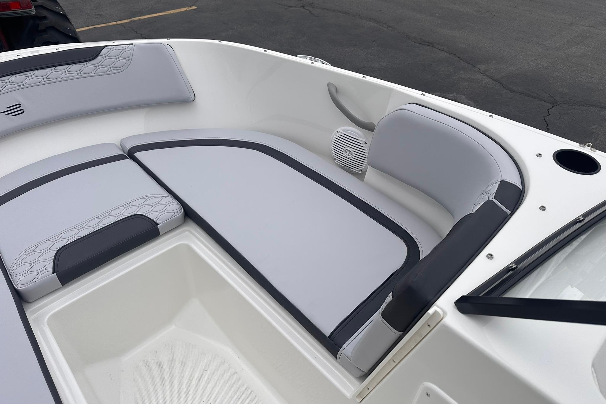 2026 Bayliner M17 boat interior with cushioned seating and speaker system.