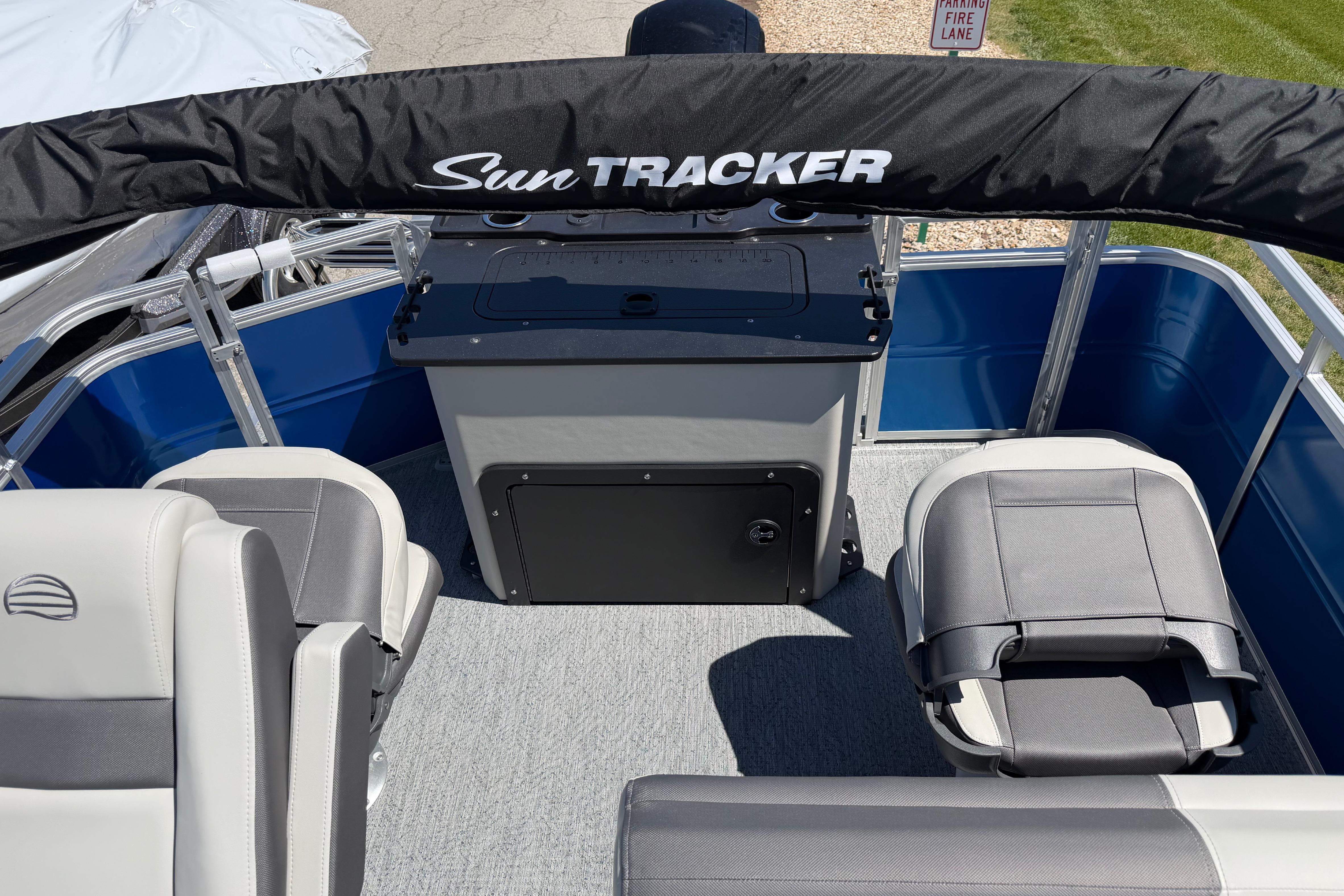 2026 Sun Tracker Fishin' Barge 20 DLX interior with seating and storage.