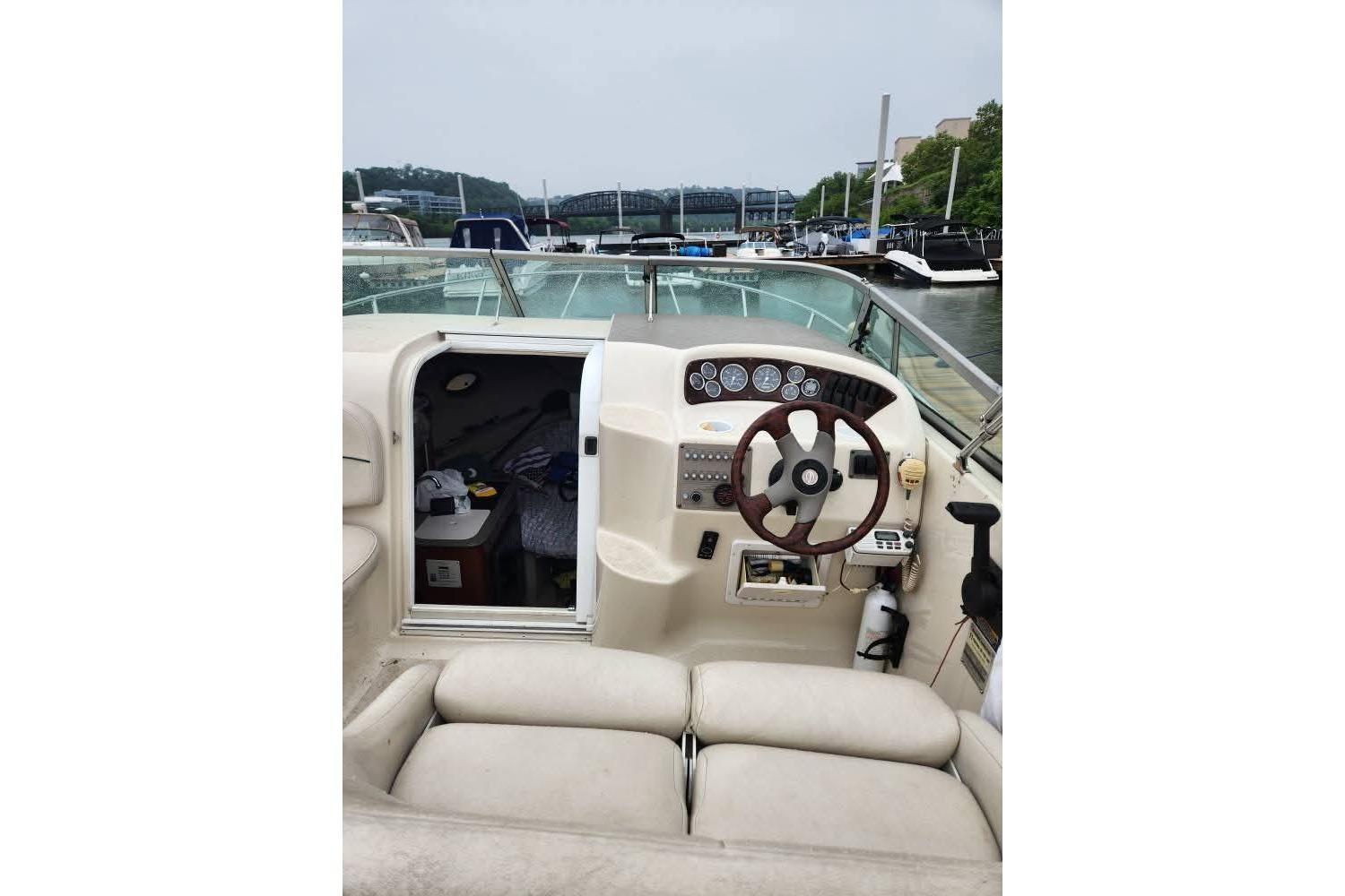 2001 Crownline 242 CR boat interior with helm, steering wheel, and cabin entrance.