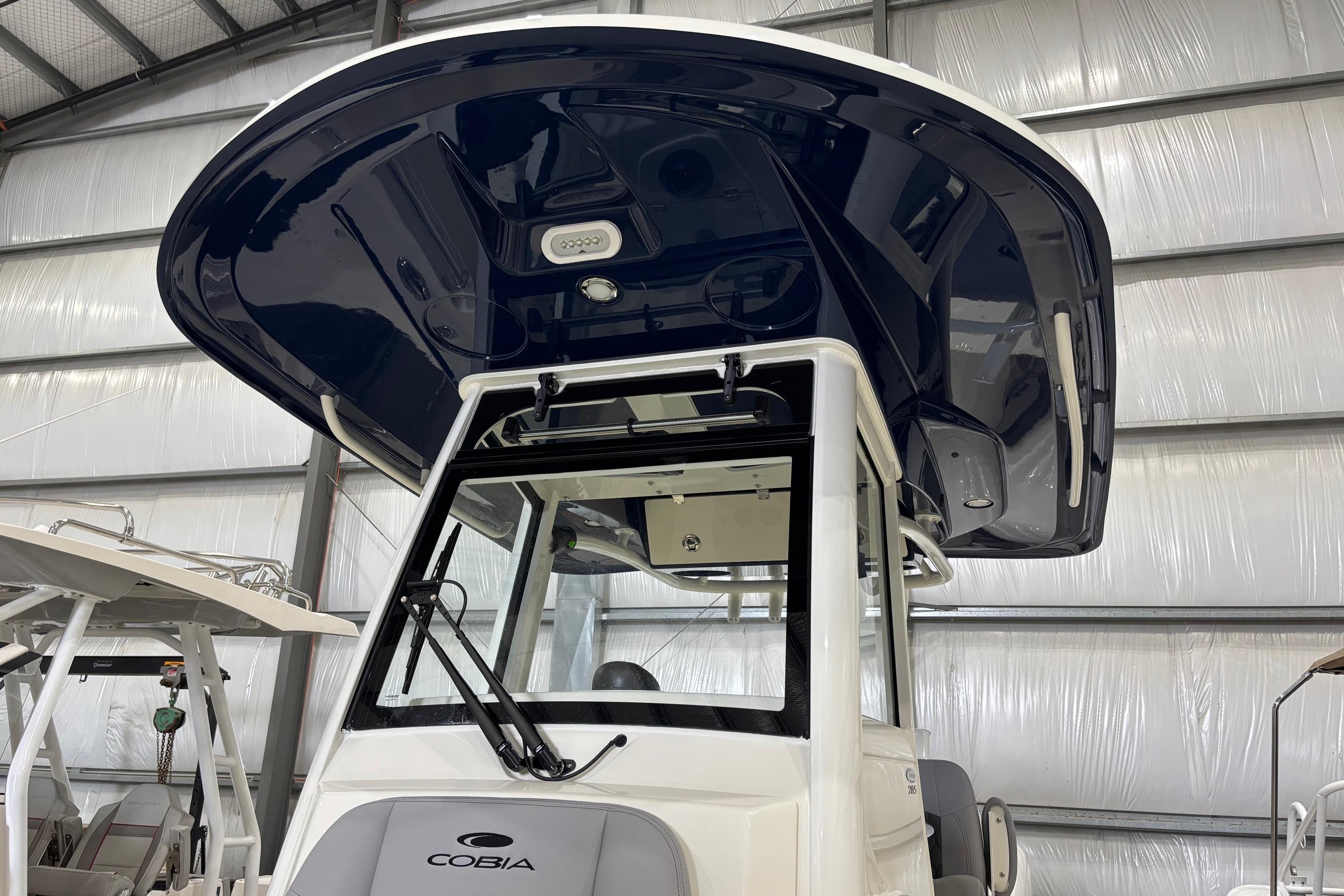 2026 Cobia 285 Open Center Console boat in a storage facility.