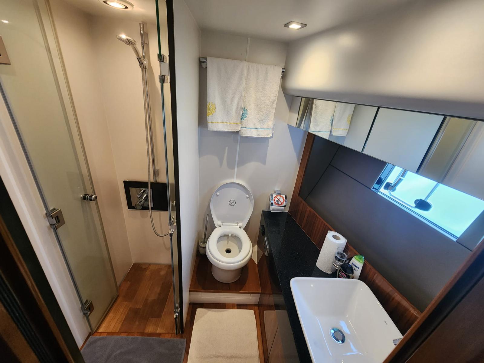 Luxurious bathroom in 2012 Fairline Squadron 65 yacht with shower, toilet, and sink.