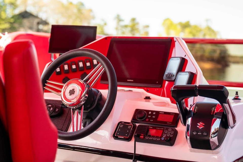 2024 Aloha Pontoon 50' Water Taxi dashboard with steering wheel and control panel.