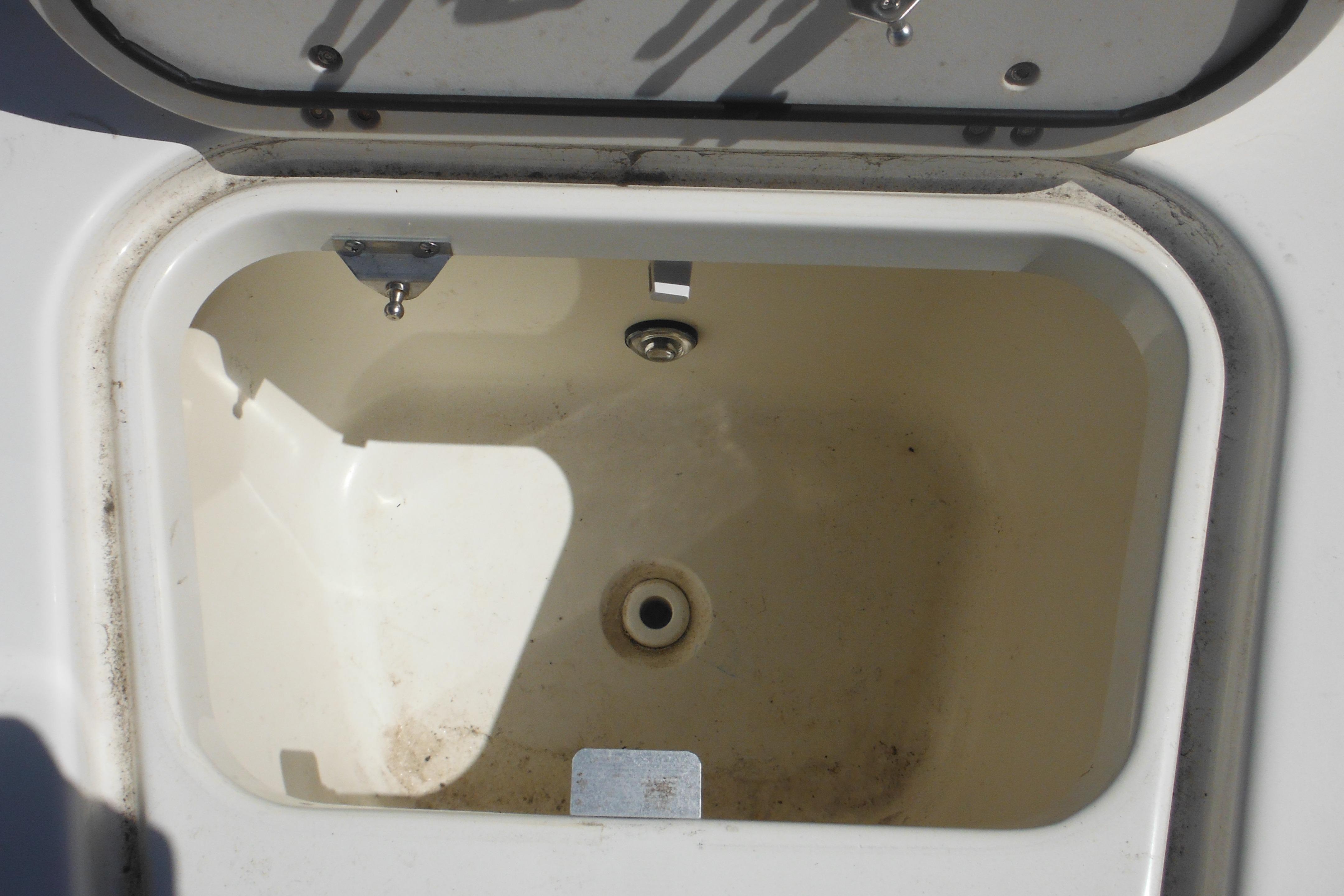Open storage compartment on a 2009 Boston Whaler 200 Dauntless boat.