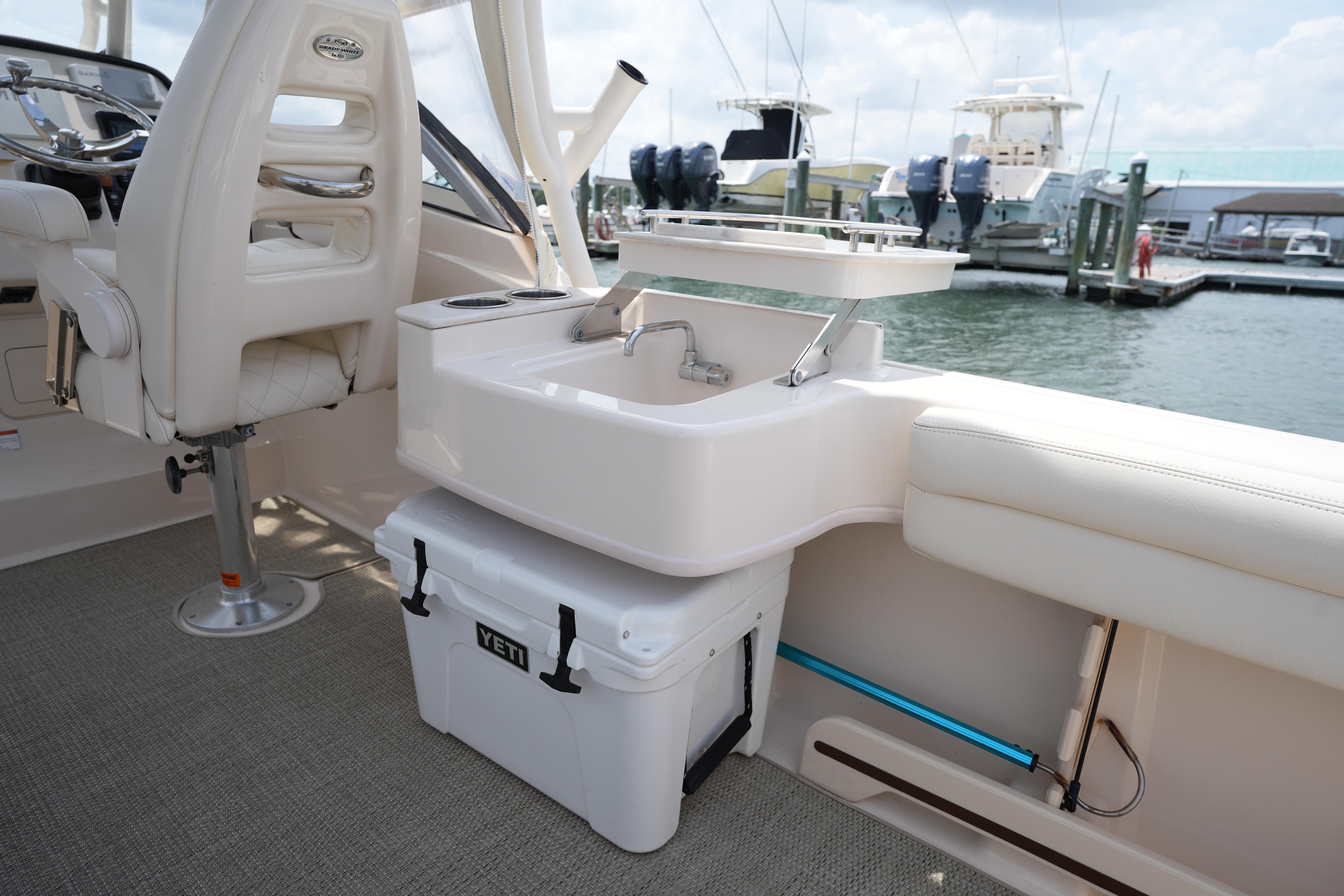 2021 Grady-White Freedom 235 boat interior with seating, sink, and Yeti cooler.
