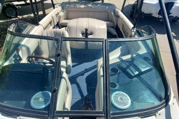 2000 Calabria Sport Comp XTS boat interior with beige seating and dual speakers.