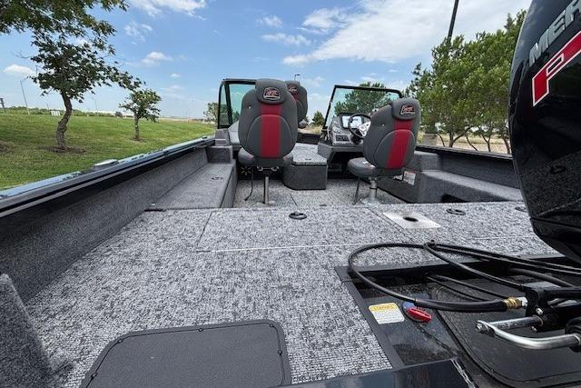 2026 Ranger VS1782SC Angler boat interior with seating and motor, under a clear blue sky.