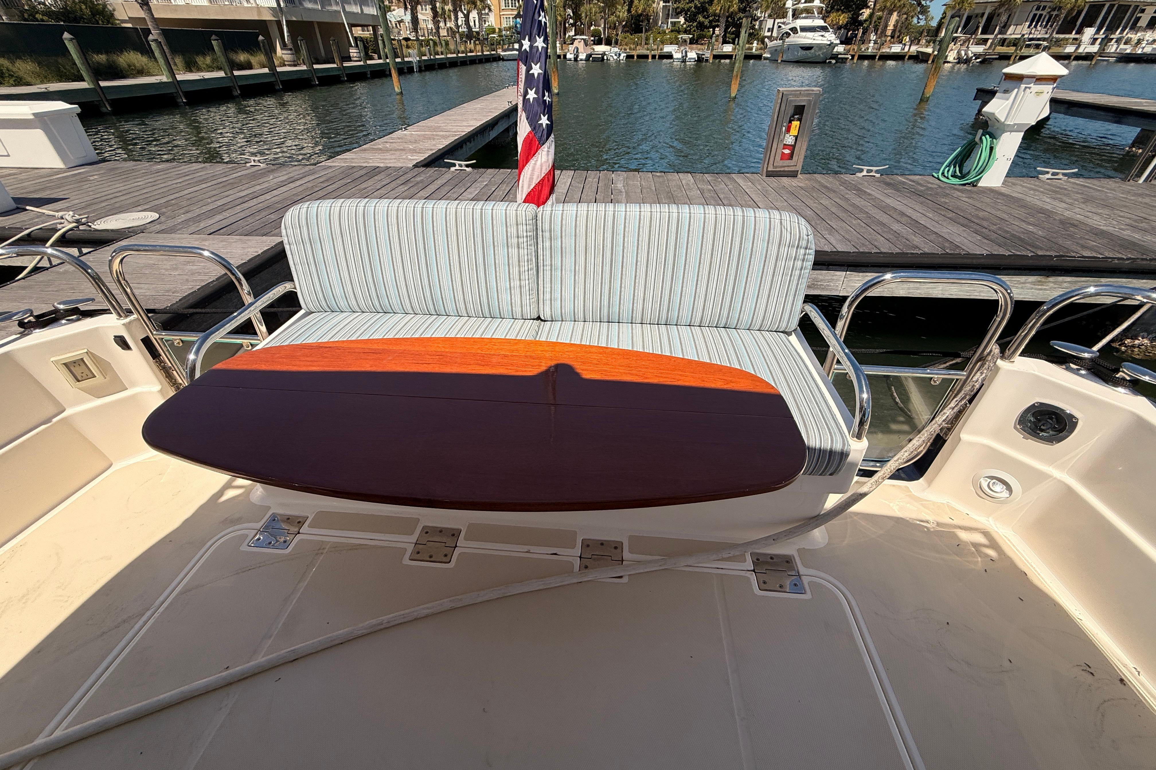 2022 Sabre 38 Salon Express yacht with cushioned seating and wooden table on deck.
