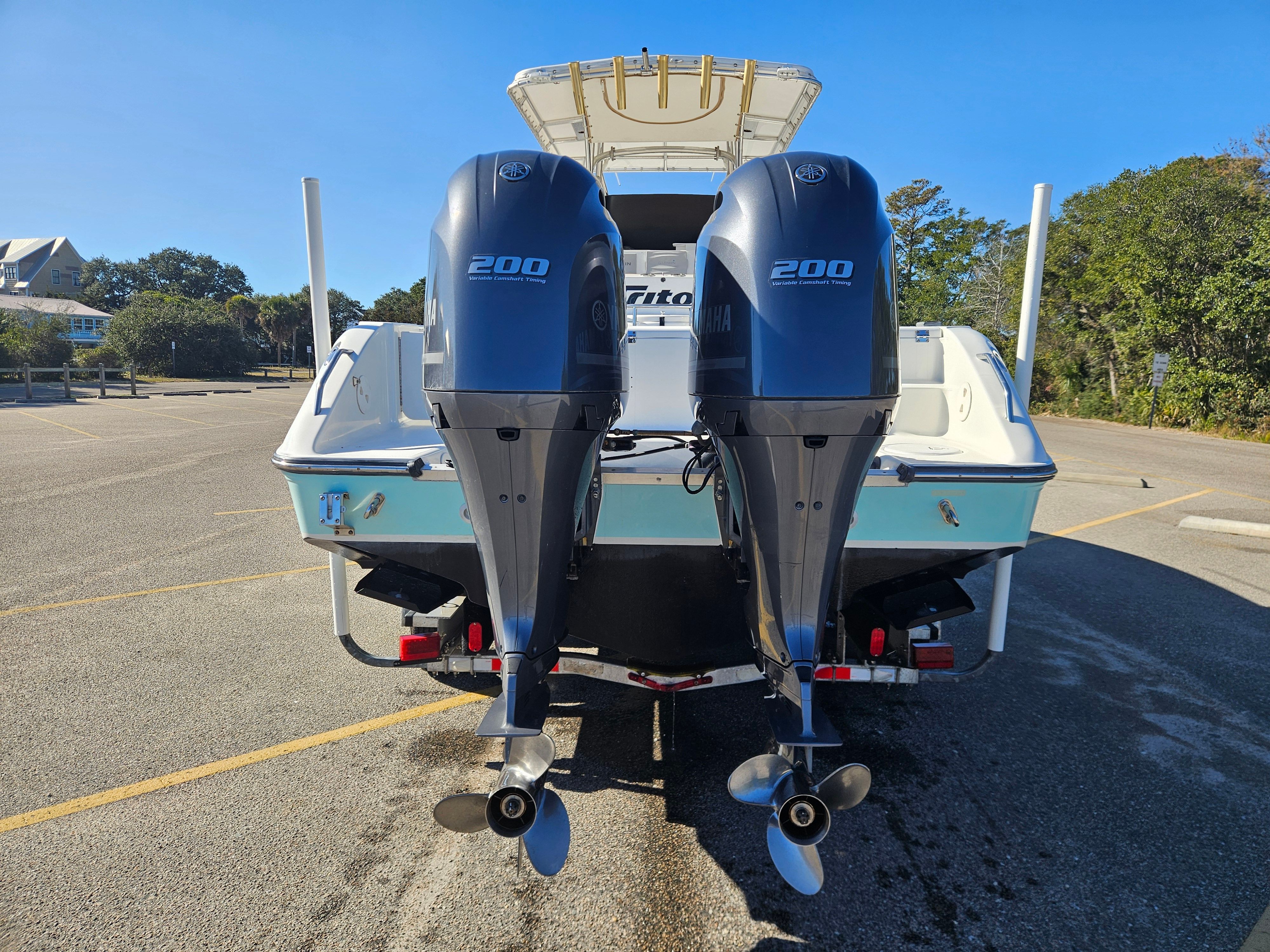2004 Triton 2690 CC boat with dual outboard engines.