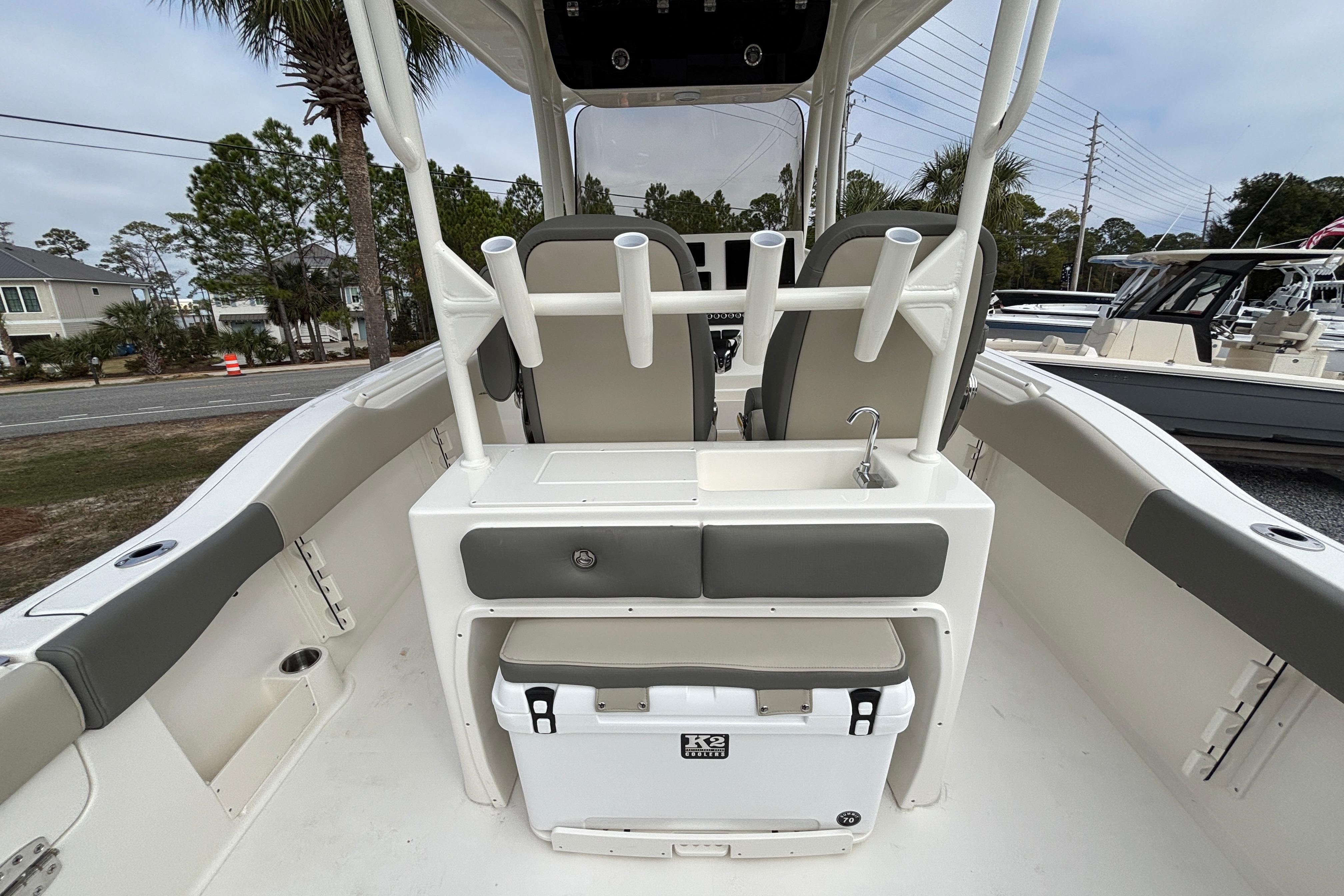 2026 Key West 263 FS boat interior with seating, rod holders, and a sink.