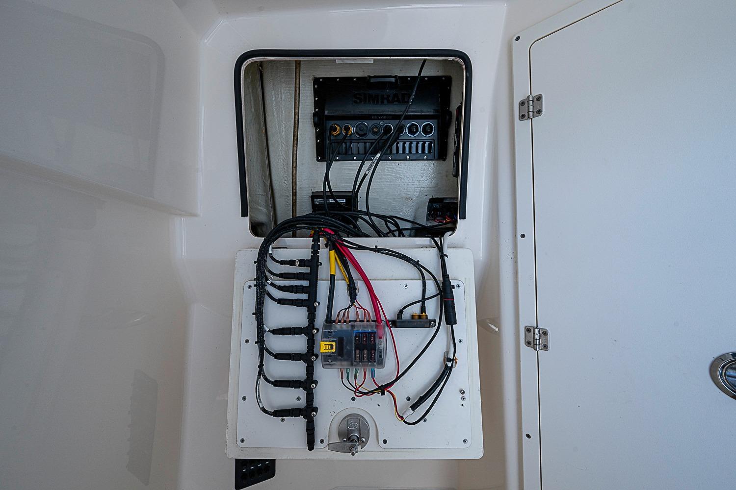 Electrical panel inside a 2019 Cobia 320 Center Console boat, showcasing wiring and components.