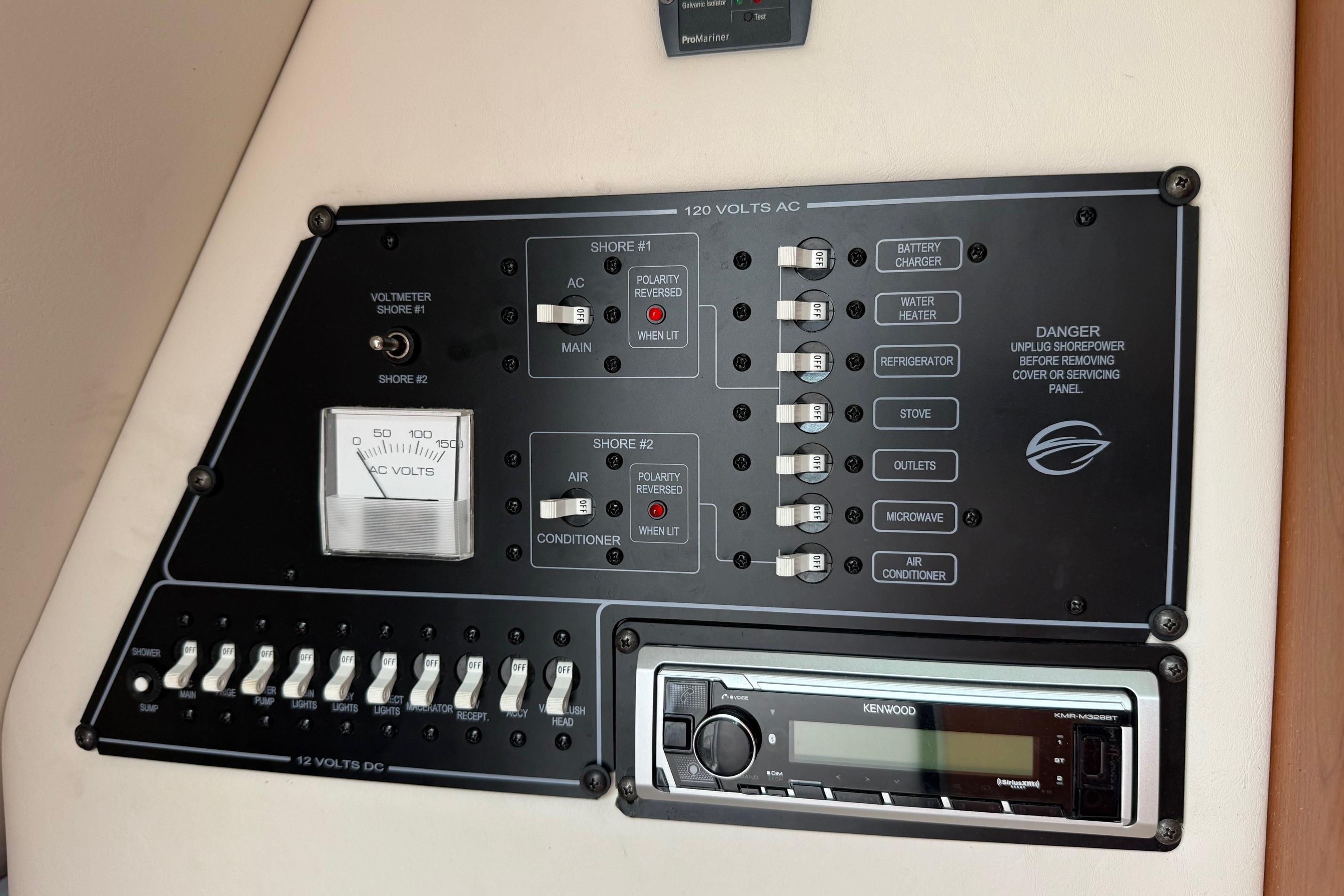 Control panel of a 2005 Crownline 250 CR boat with switches and voltmeter.