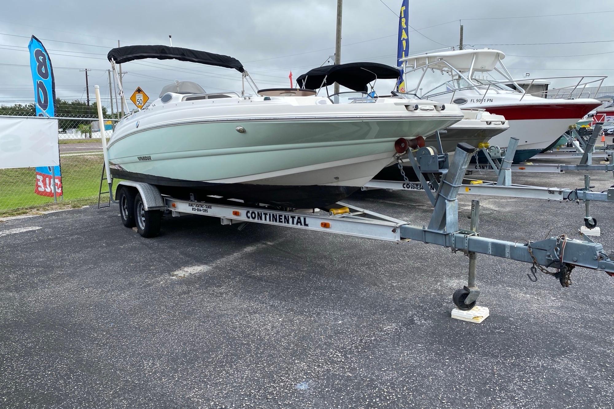 2018 Stingray 212 SC boat on trailer, displayed outdoors at dealership.
