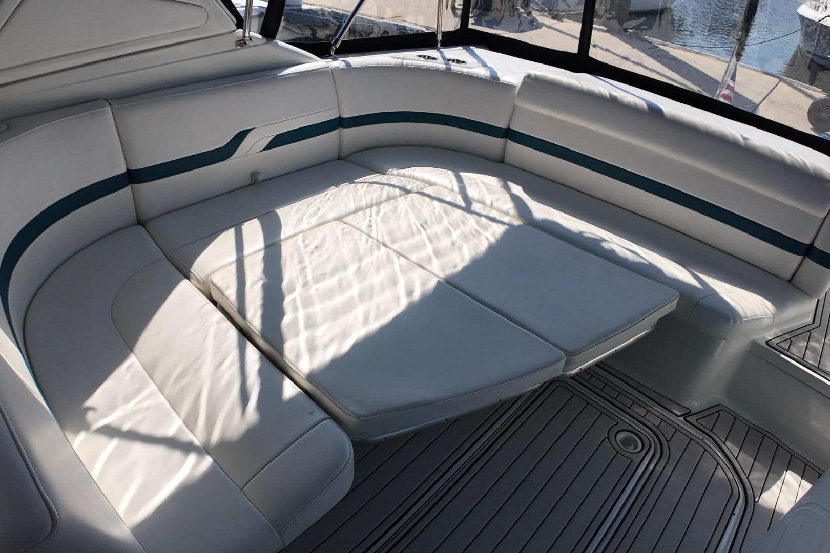 2007 Formula 330 Sun Sport boat interior with white cushioned seating and blue accents.