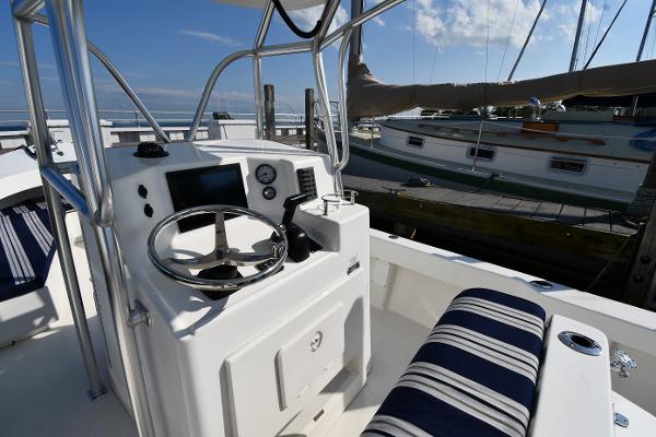 2021 Eastern 248 Center Console boat interior with steering wheel and striped seating.