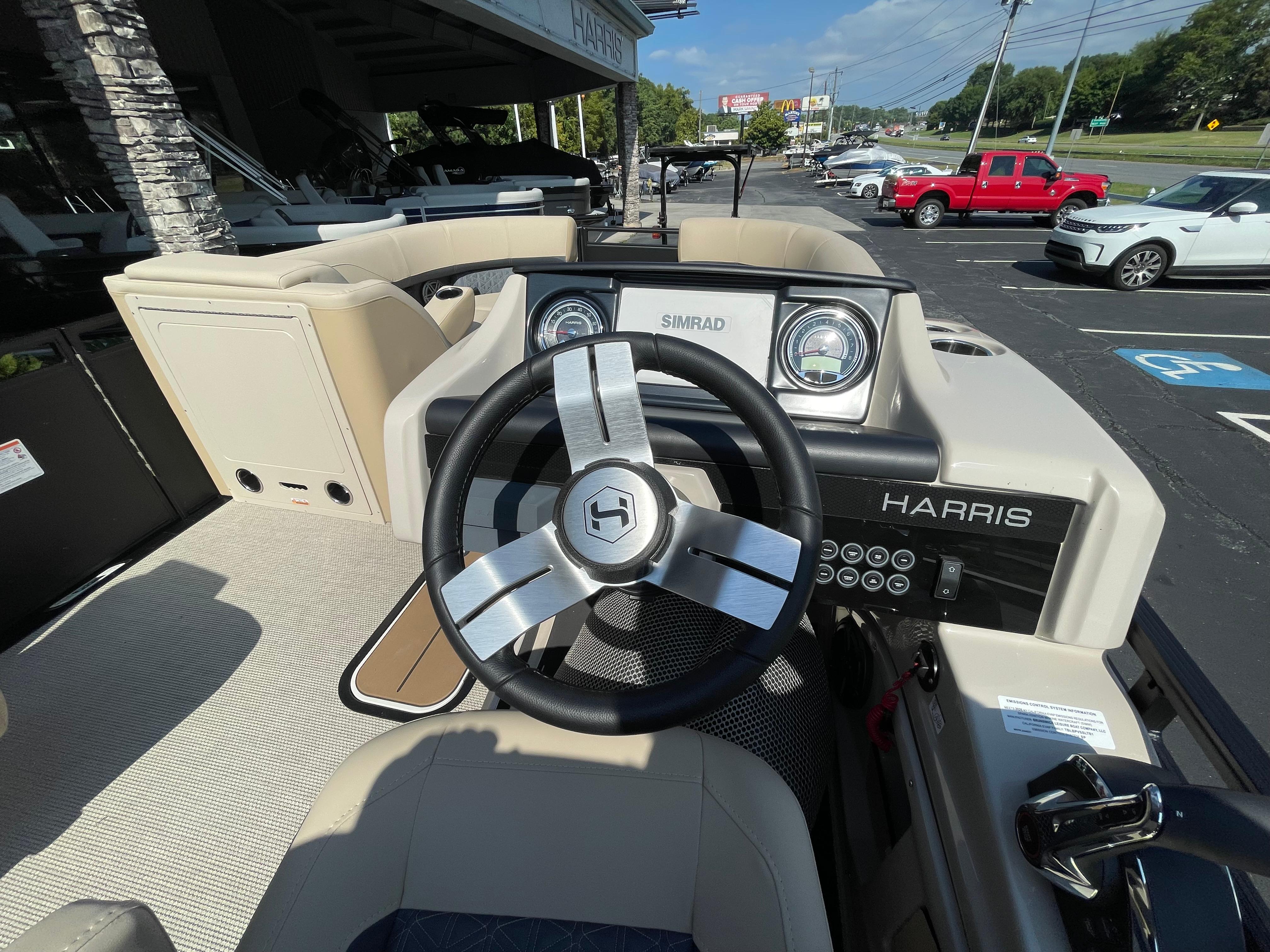2026 Harris Solstice 230 boat dashboard with steering wheel and control panel.