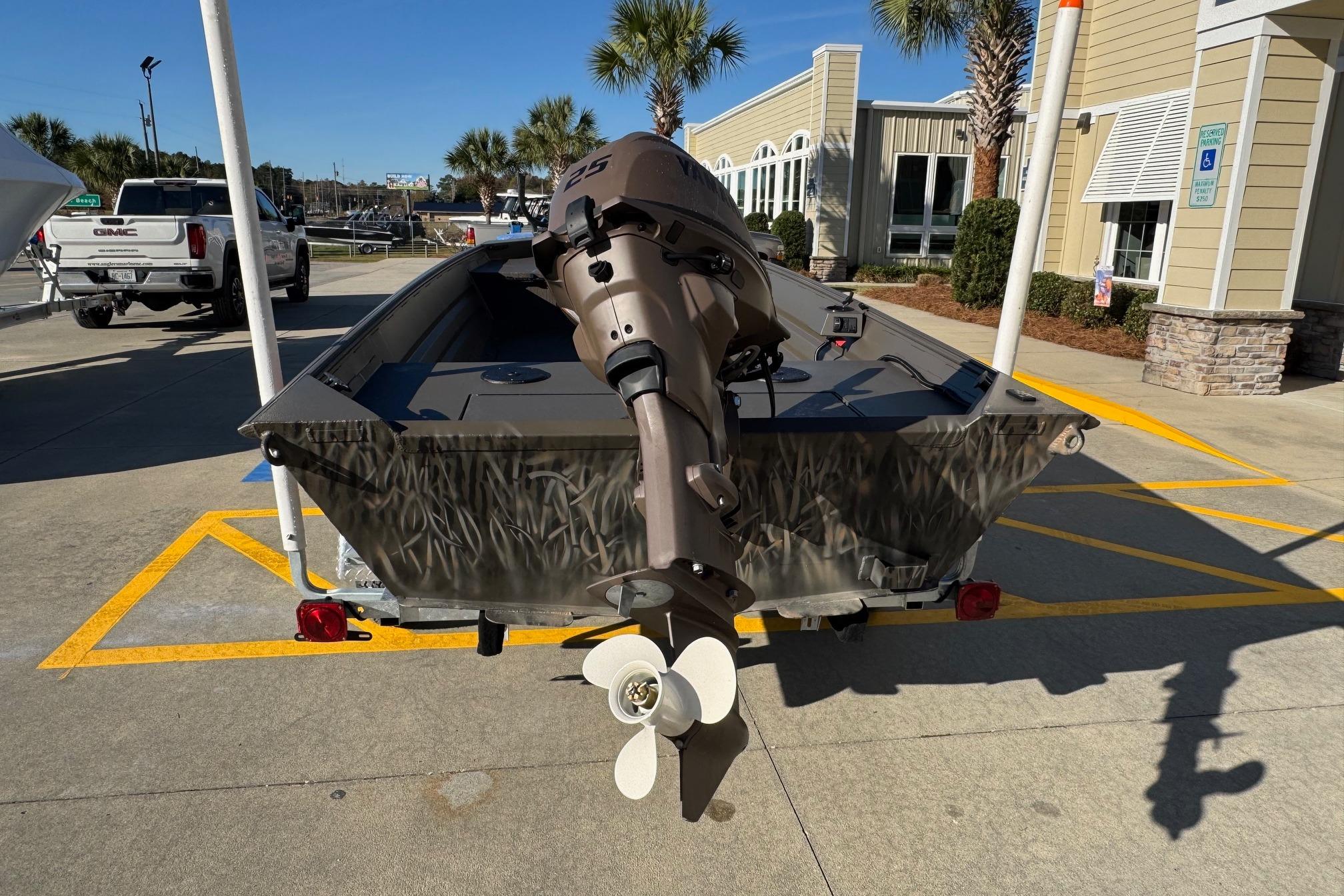 2026 Alweld 1652VV Marsh boat with outboard motor in a parking lot.