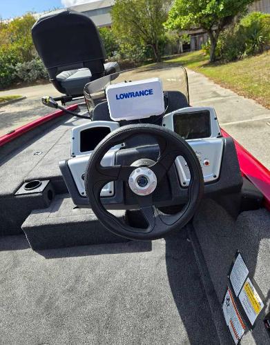 2025 Tracker Pro Team 175 boat dashboard with Lowrance electronics, steering wheel, and seating.
