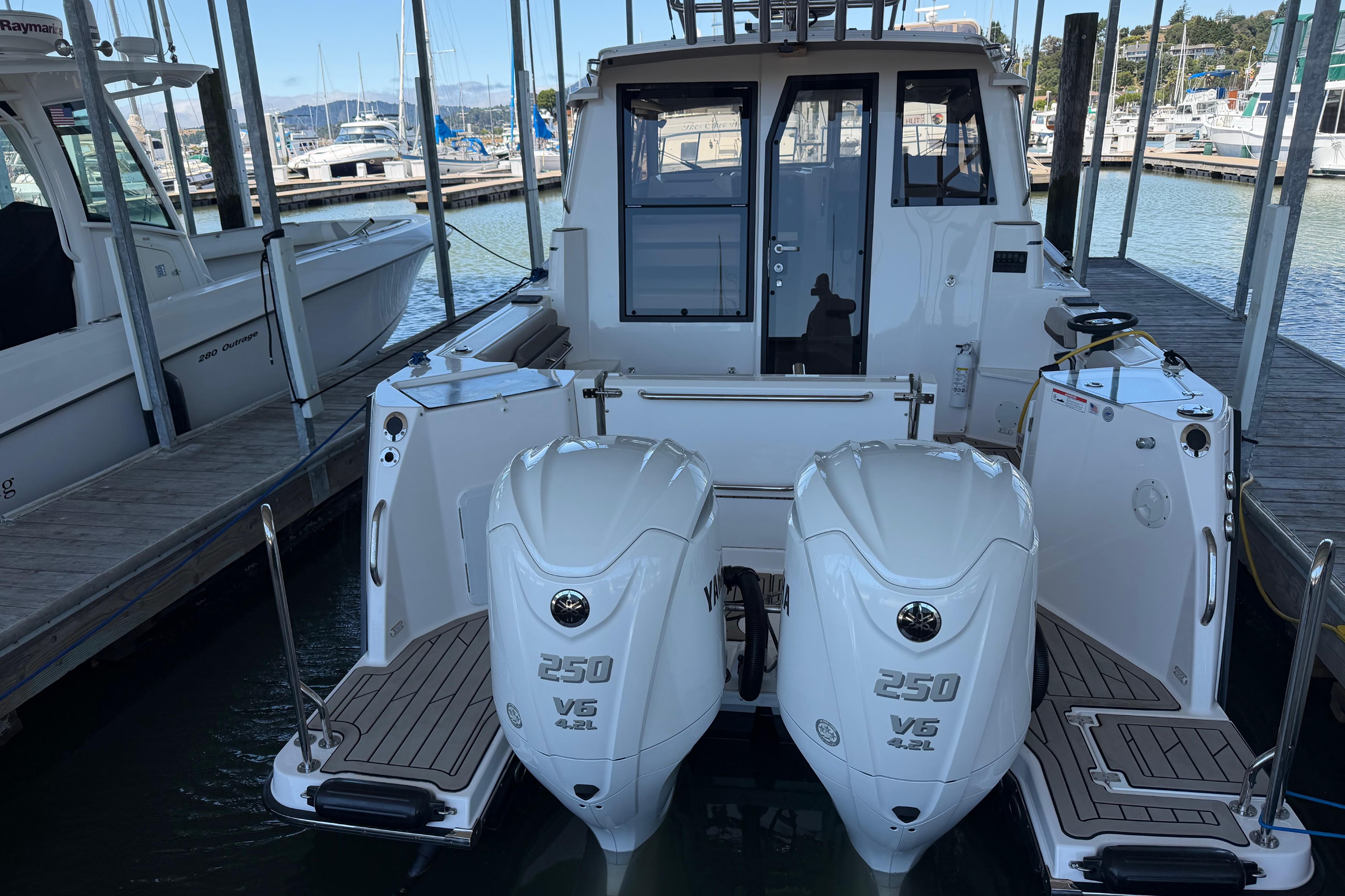2023 Cutwater C-288 Coupe with twin 250 V6 engines docked at a marina.