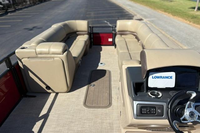 2025 Regency 250 DL3 pontoon boat interior with beige seating and Lowrance navigation system.
