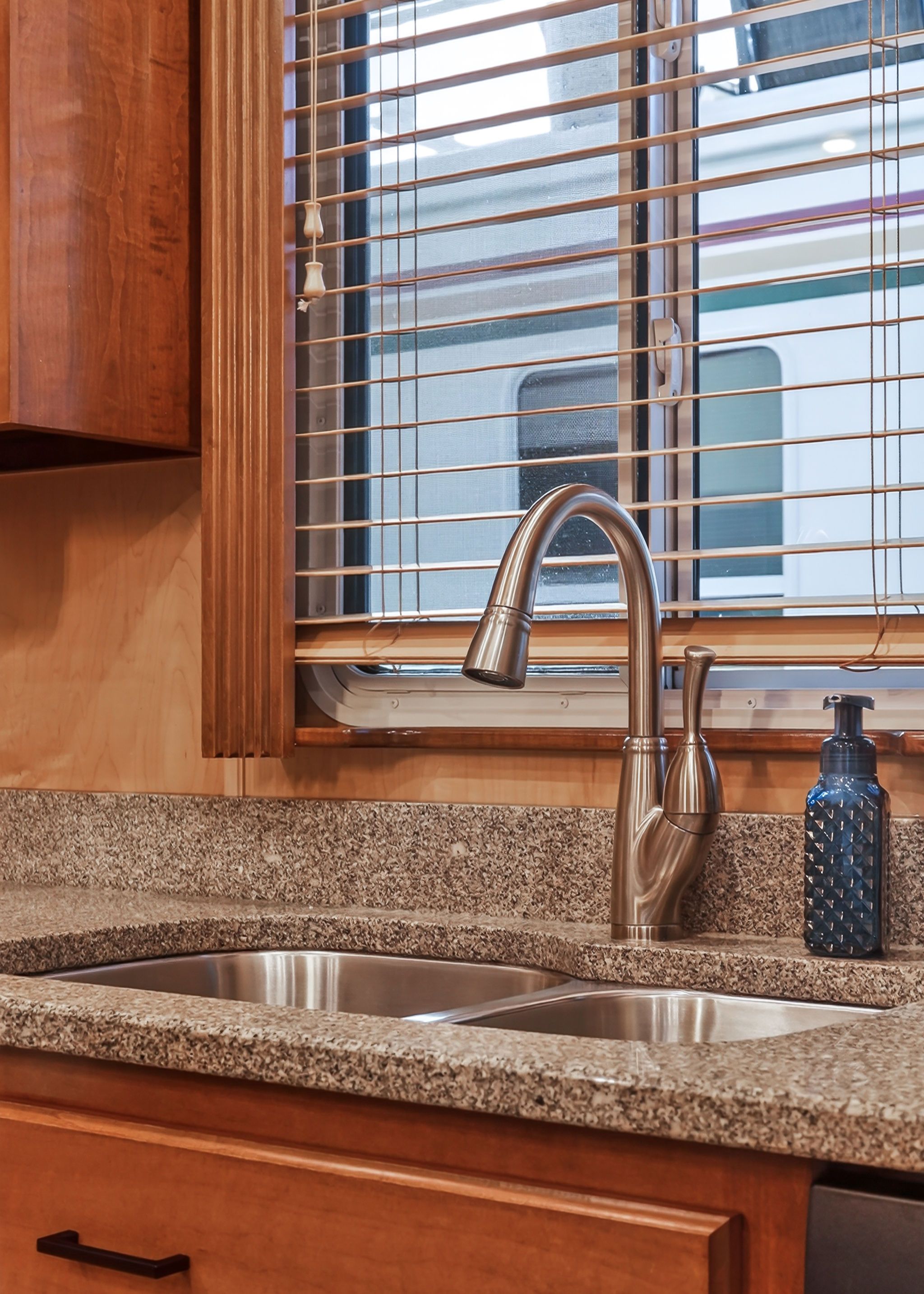 Kitchen area in a 2010 Houseboat with granite sink and window.