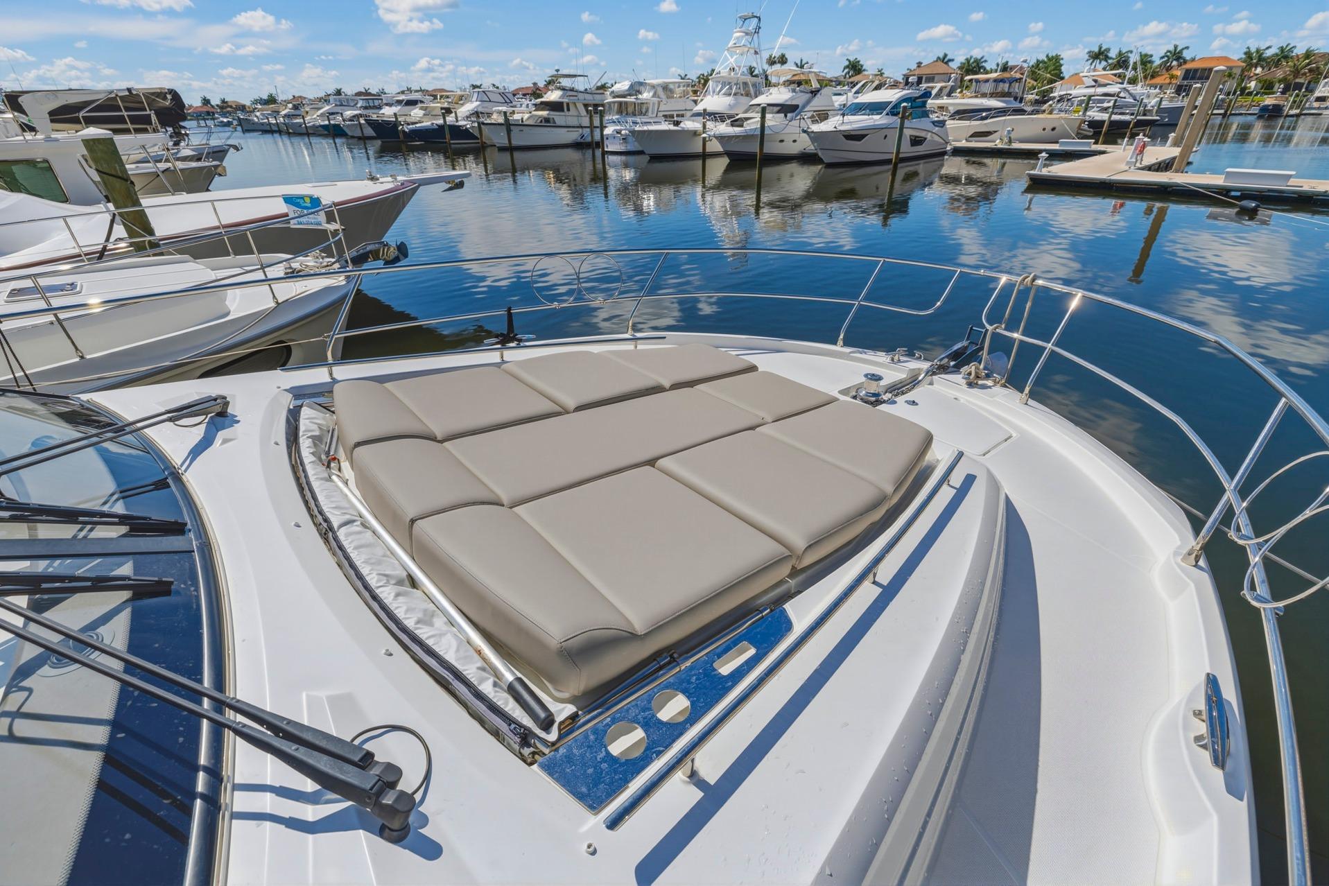 Prestige 520 yacht, 2022 model, docked with sunbathing cushions on deck.