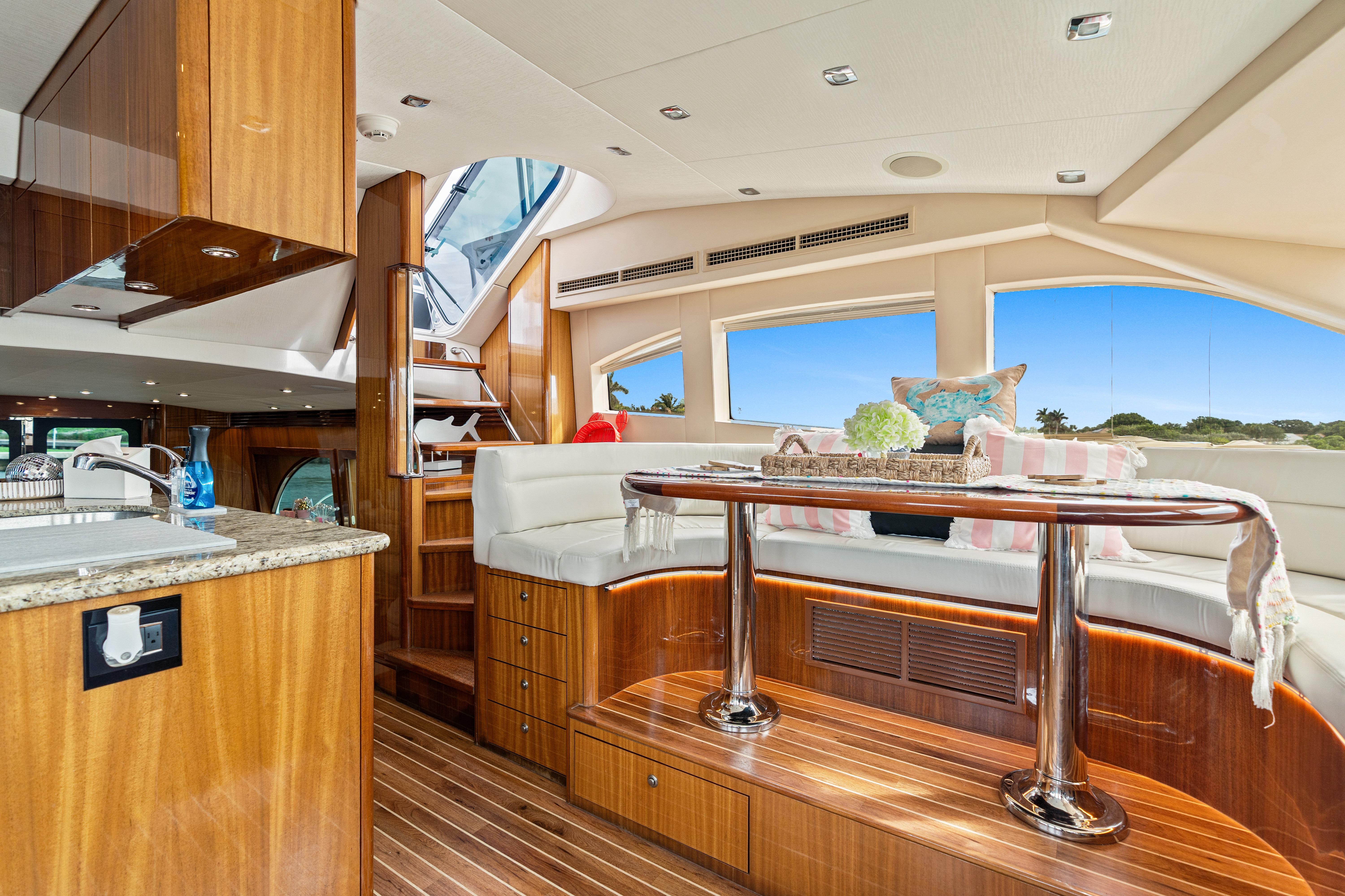 Luxurious interior of 2008 Hatteras 64 Motor Yacht with elegant wood finishes and plush seating.