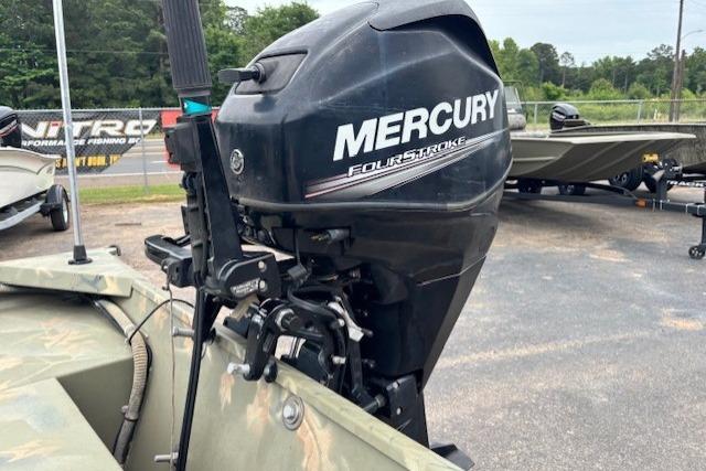 2017 Tracker Grizzly 1654 MVX Sportsman with Mercury FourStroke outboard motor in a parking lot.