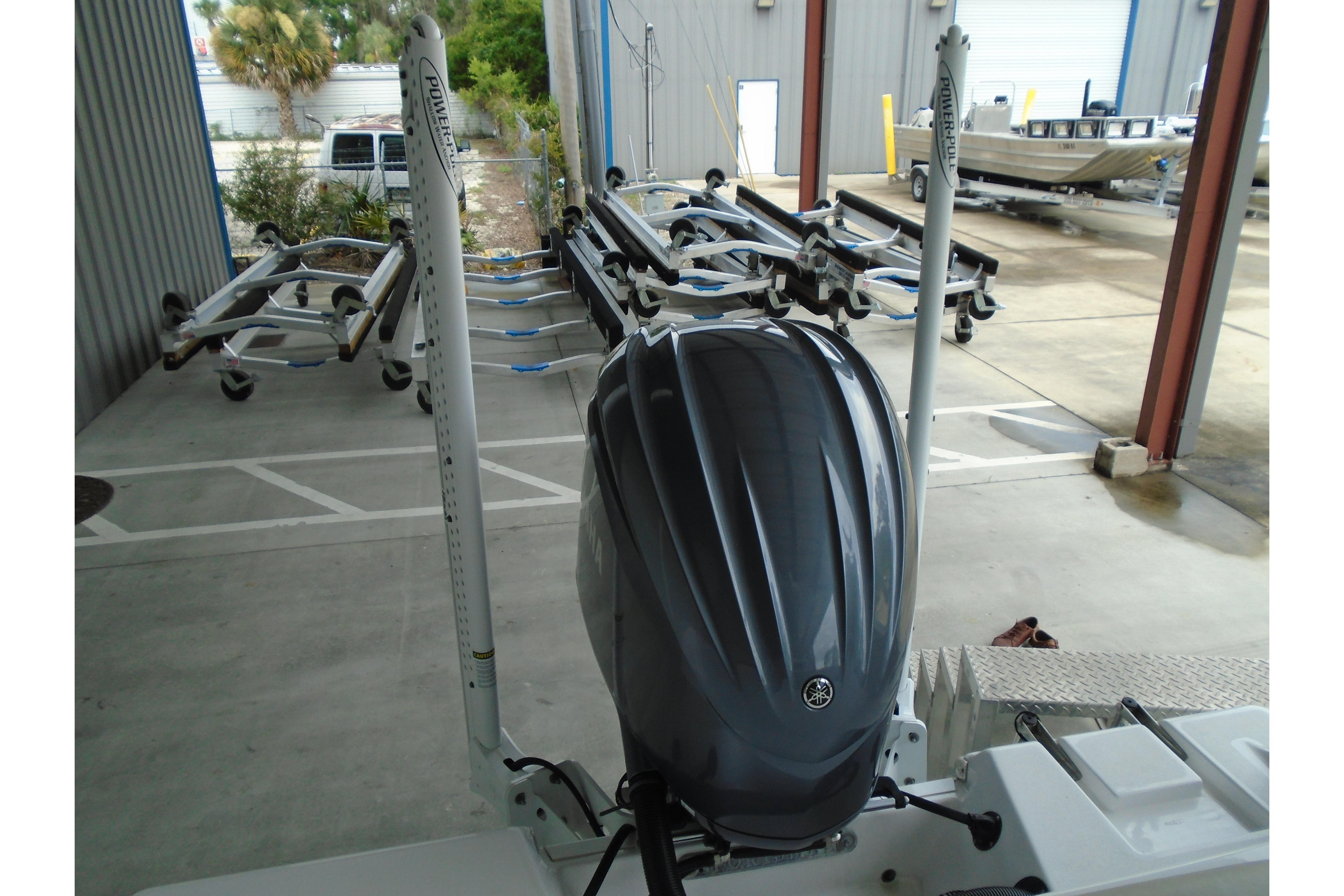 2022 Sportsman Heritage 241 Center Console with outboard motor in a storage facility.