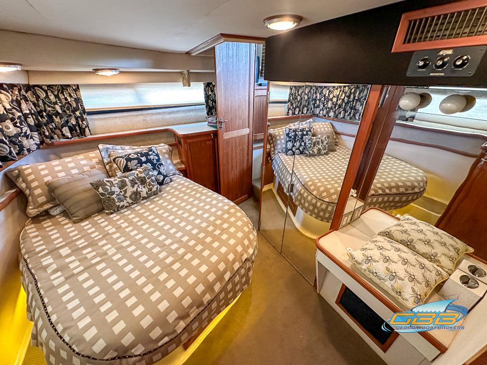 Interior of 1989 Carver 3807 Aft Cabin with cozy bed and mirrored closet.