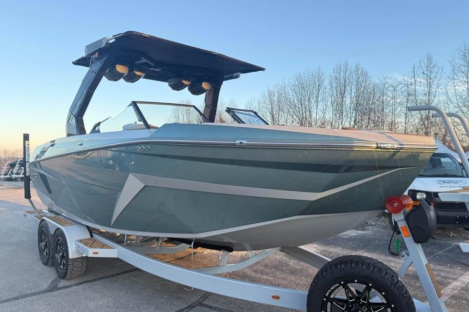 2026 Tigé Z3 boat on trailer, sleek design, parked outdoors.