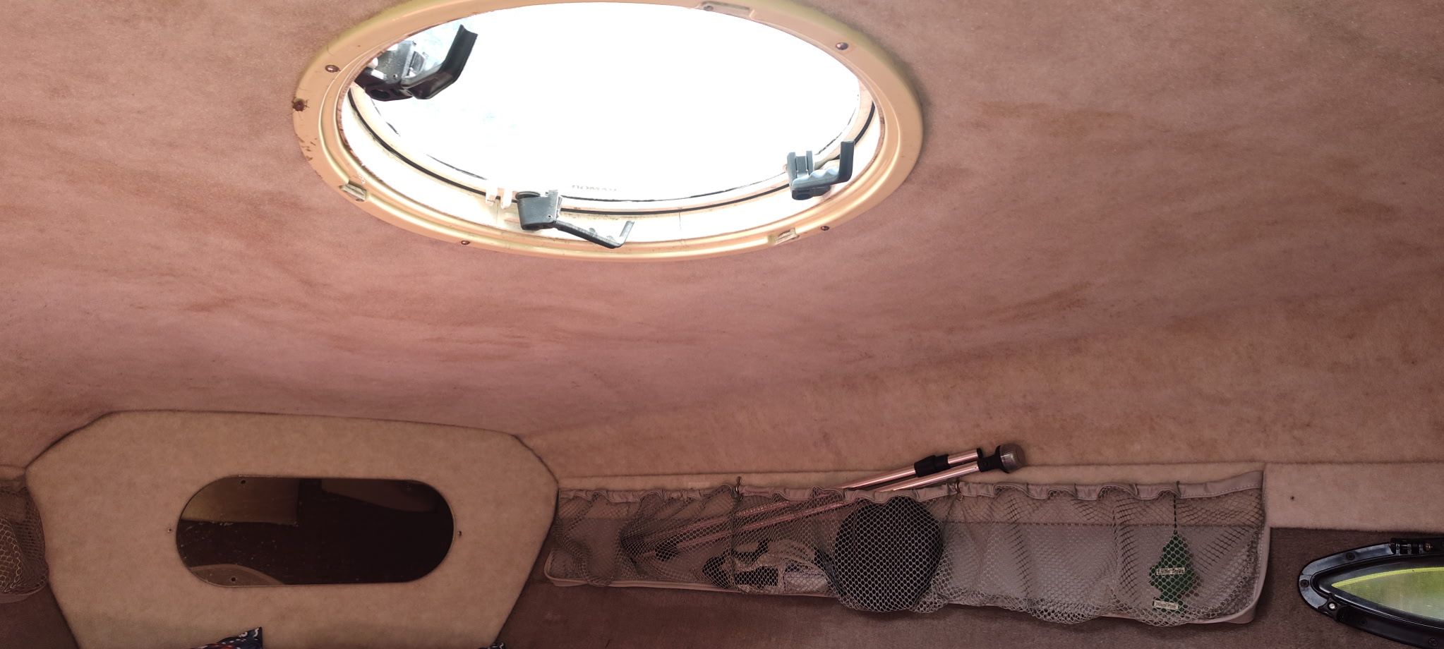 Interior of the 2002 Stingray 240 CR with porthole and mesh storage pockets.