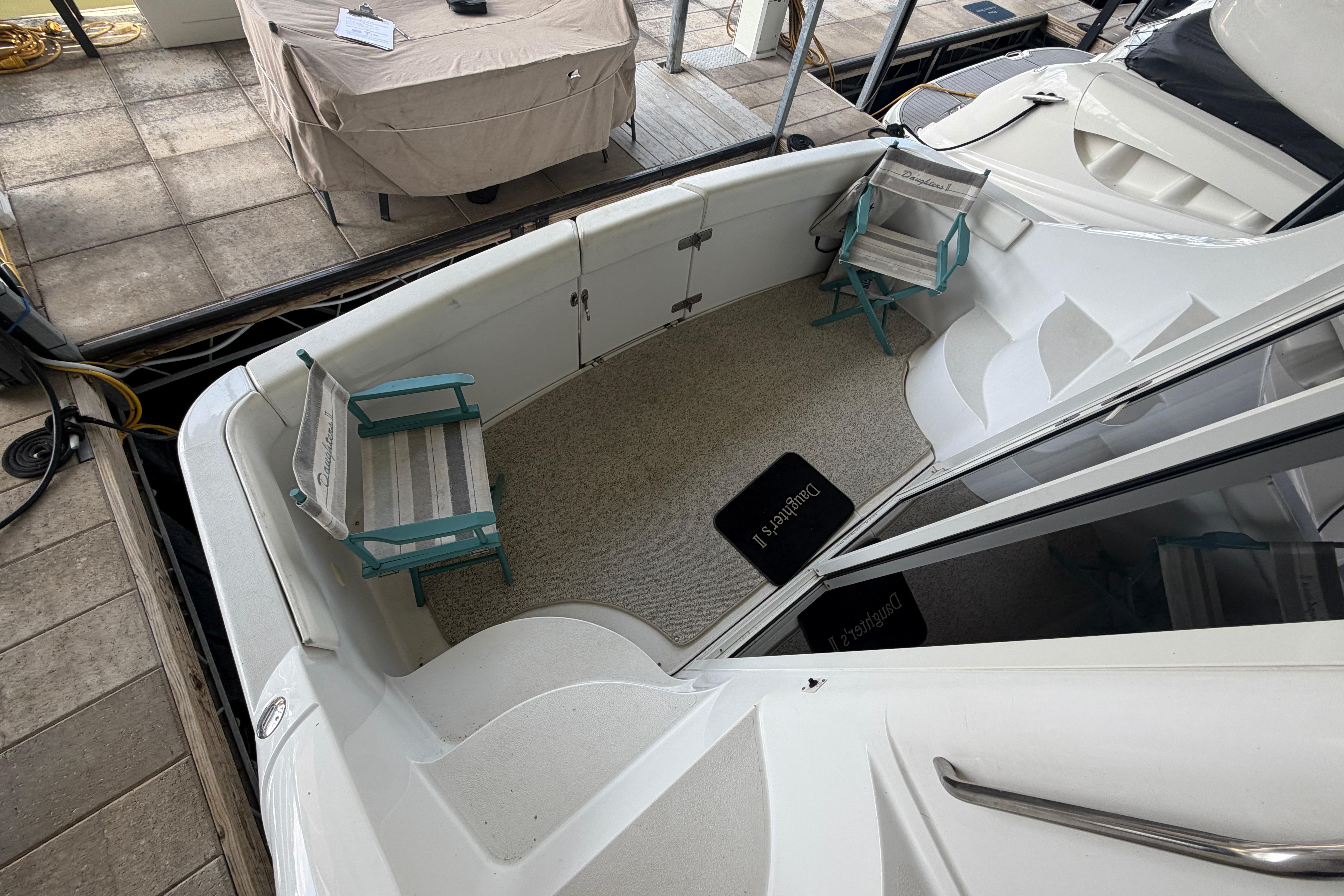 2000 Carver 350 Mariner boat deck with chairs and covered table.