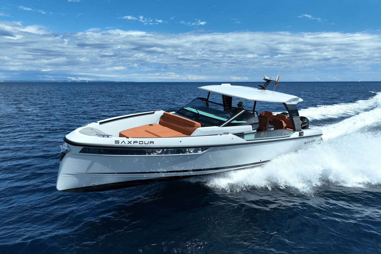 A Saxdor SX320 GTO boat speeds across the sea under a cloudy sky.