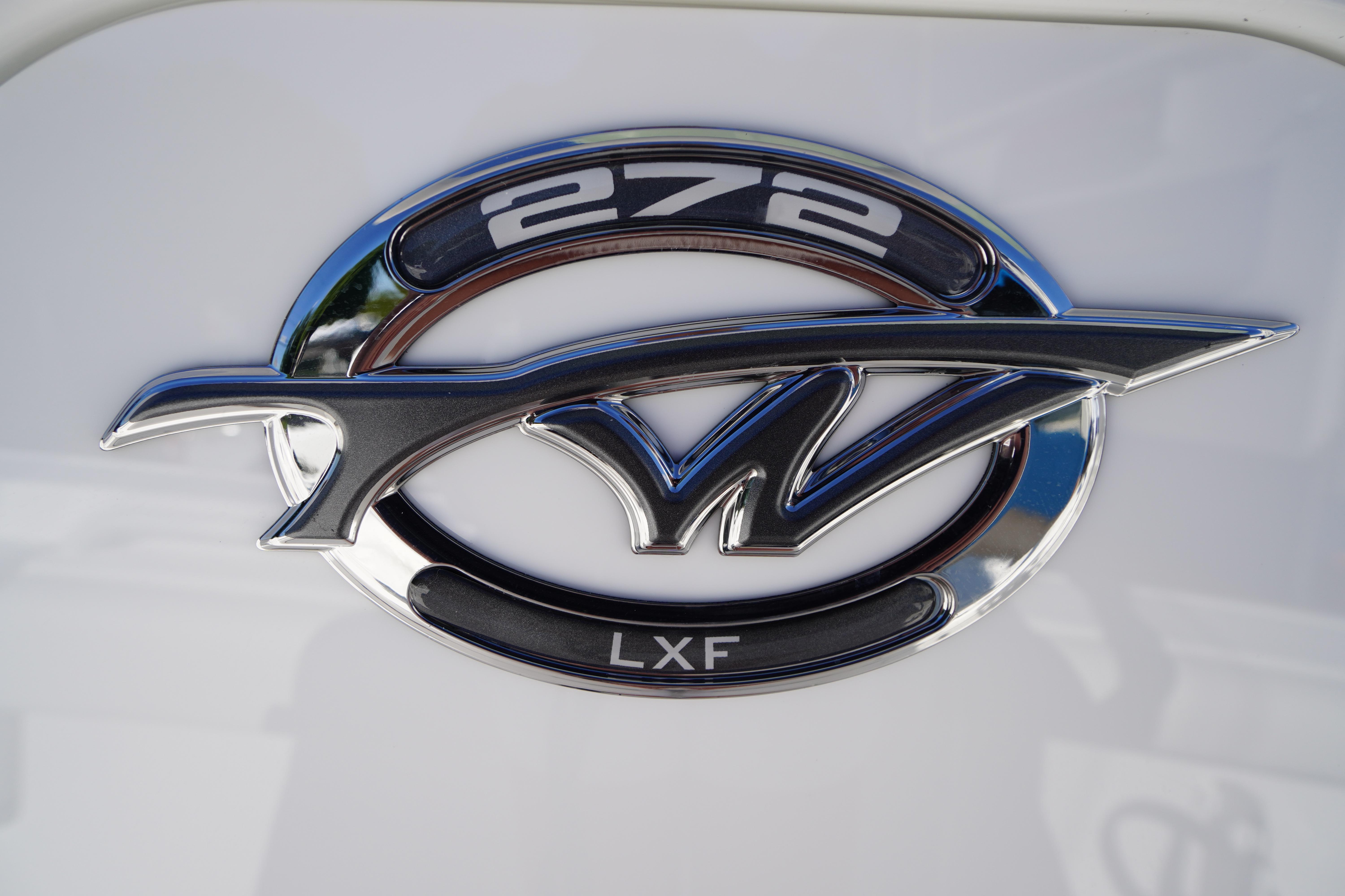 Chrome emblem of 2026 Tidewater 272 LXF boat model on white background.