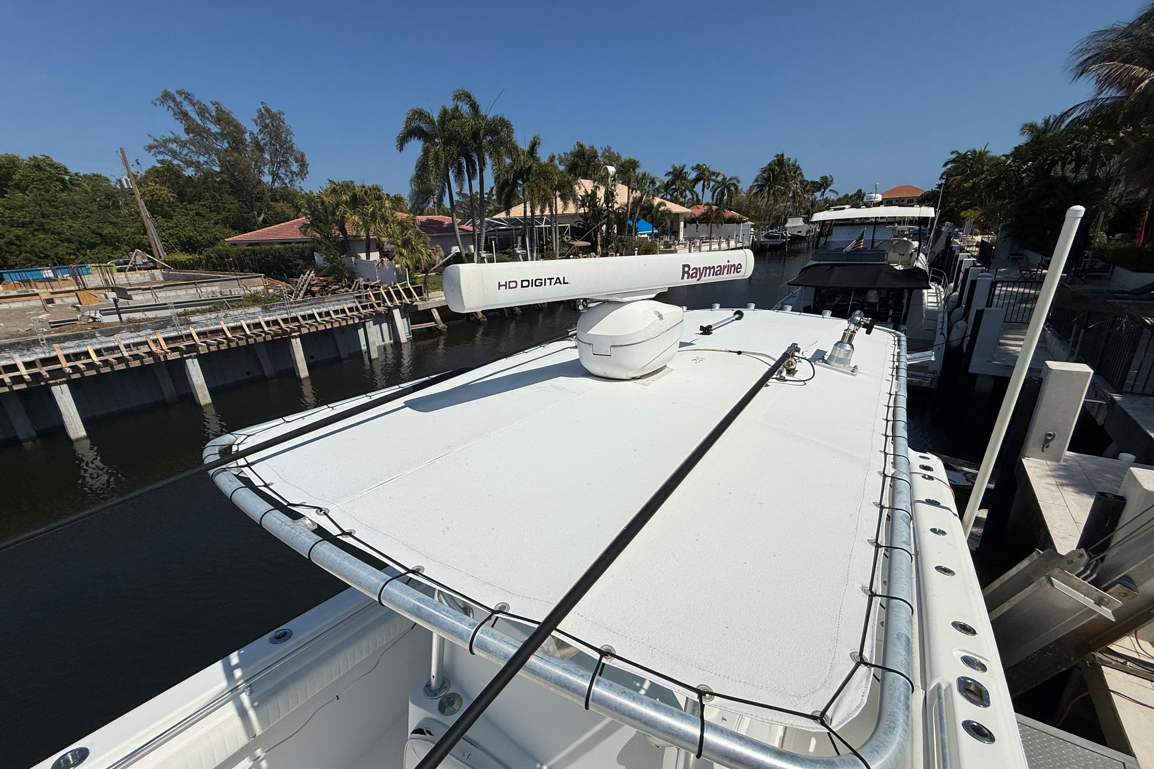 2003 Palmetto 33 Adventure boat with Raymarine HD Digital radar, docked in a scenic canal.