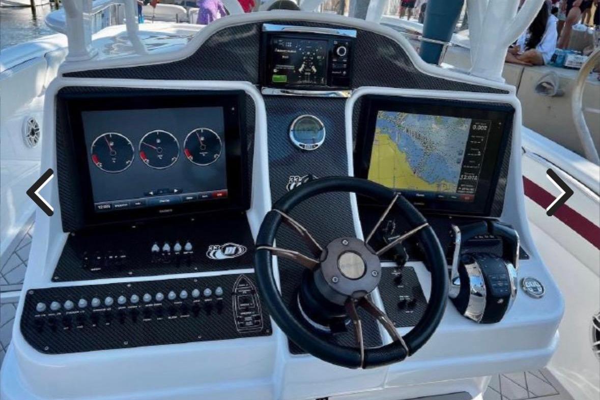 Cockpit of 2015 Deep Impact 33 boat with navigation screens and controls.
